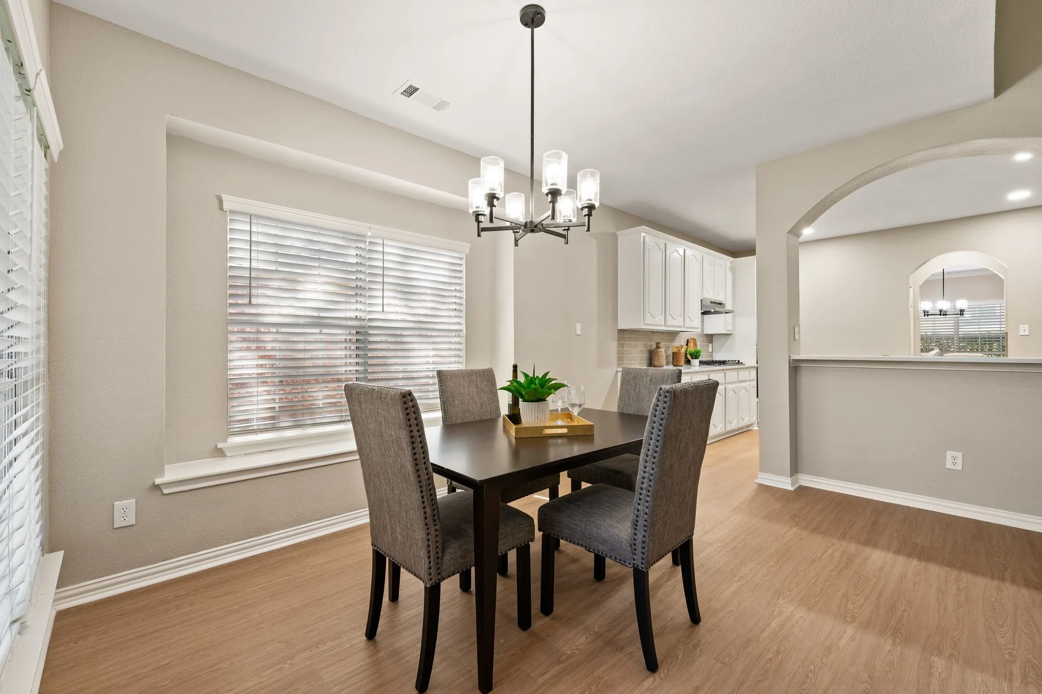 Start your mornings in the bright breakfast area, conveniently positioned beside the kitchen with generous windows & a stylish chandelier.