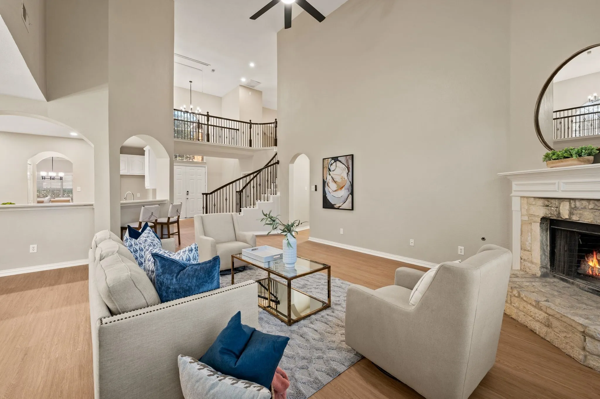Dramatic ceiling height & an overlooking upstairs railing add character to the living room, while the open layout keeps everyone connected.