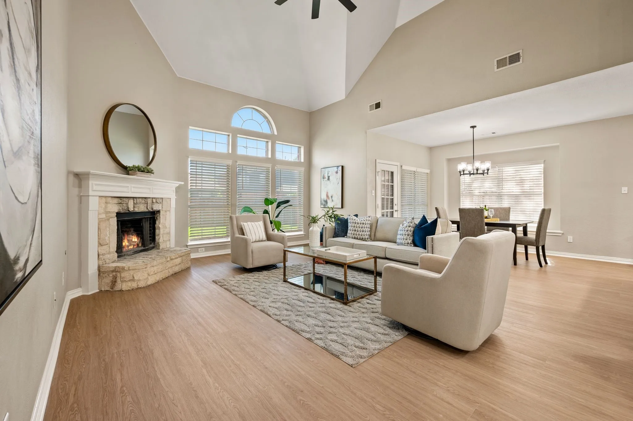 Stretch out & settle in! This airy living room features soaring ceilings, a corner fireplace & an easy connection to the breakfast area.