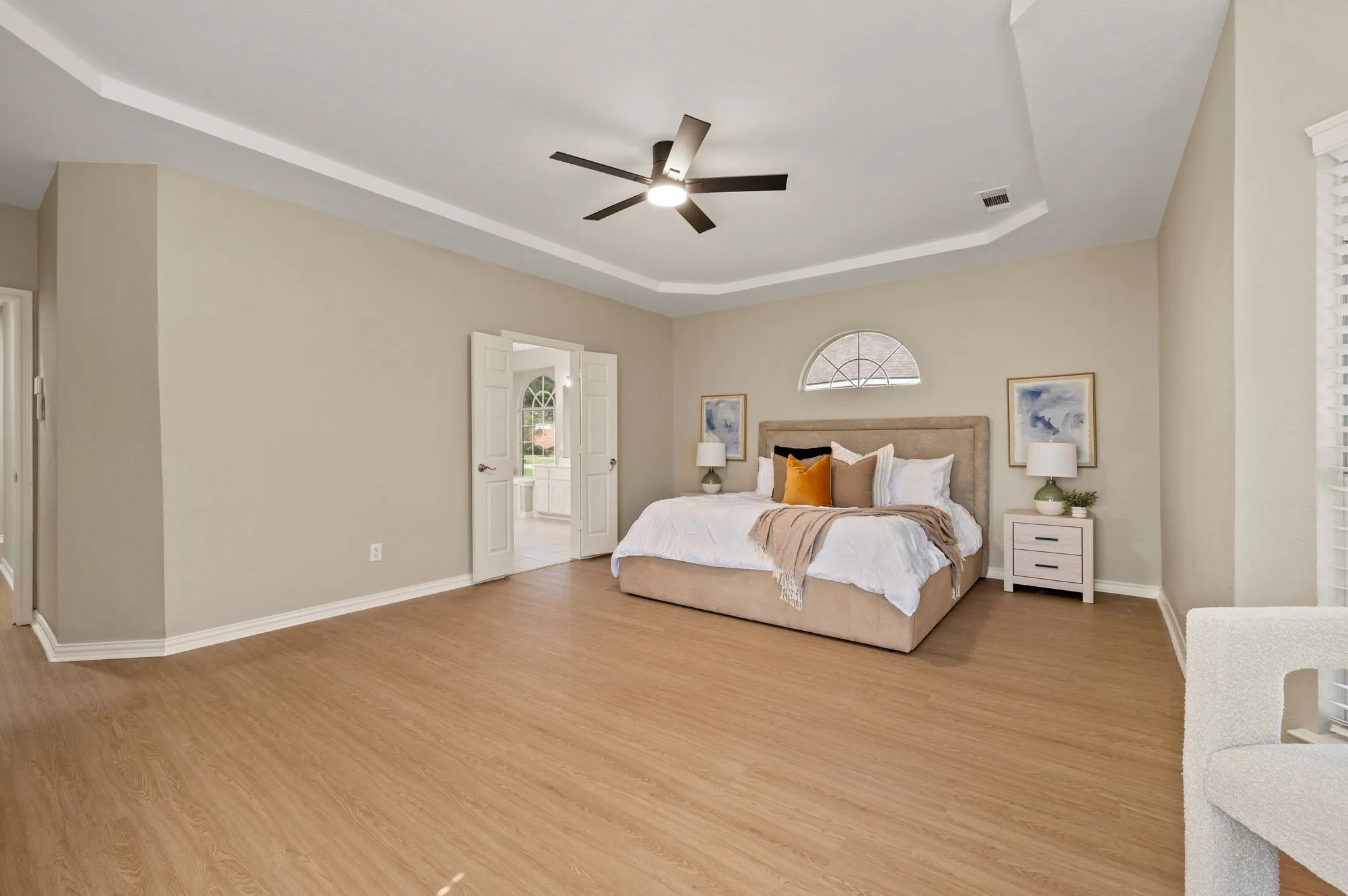 With generous proportions, warm wood-look flooring & a beautifully detailed ceiling, this bedroom offers plenty of space to relax & recharge.