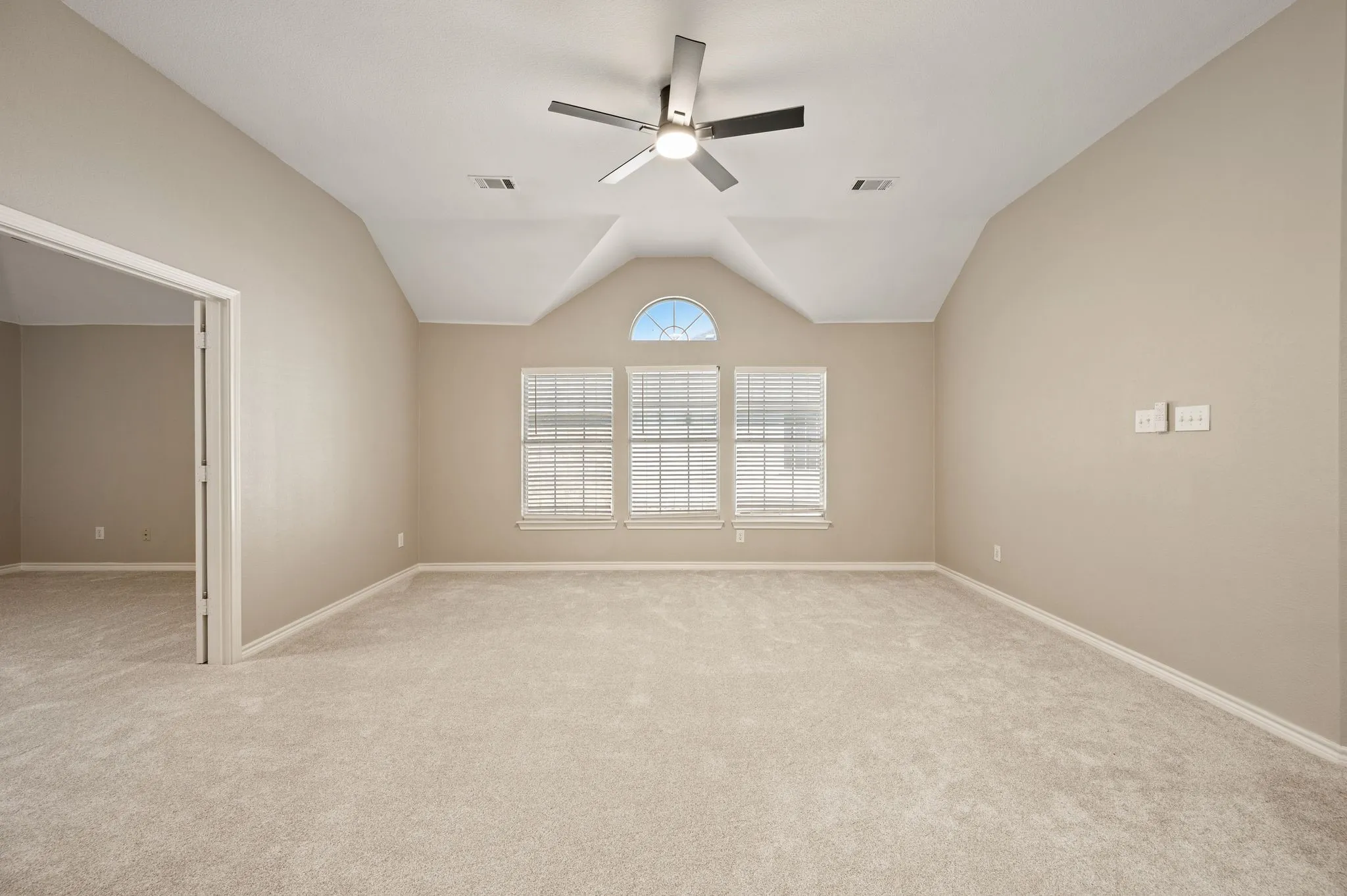 Make it your own! This spacious upstairs room features a vaulted ceiling, new carpeting & a charming arched window accent.