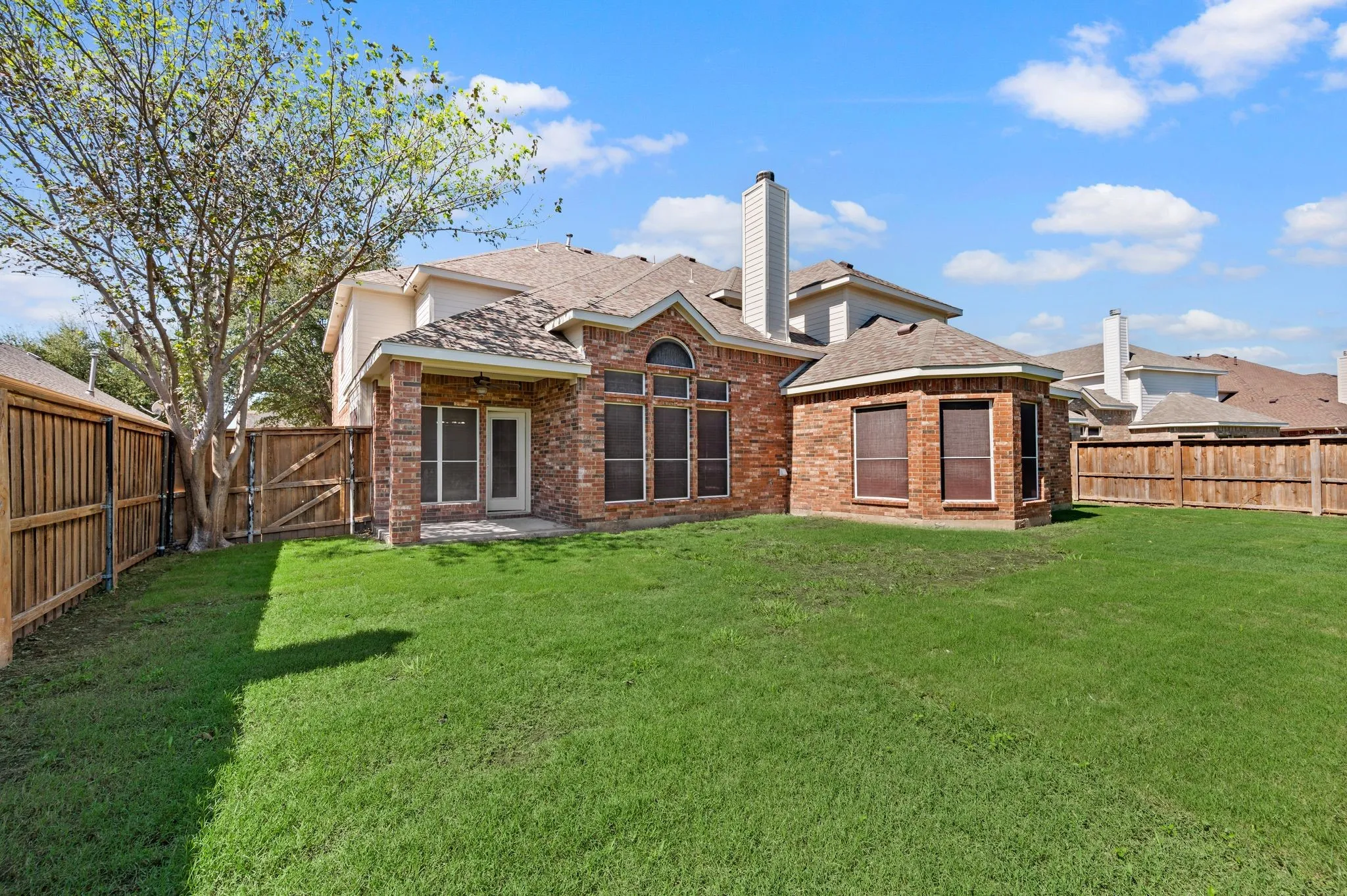 Bring the fun outside! The spacious fenced backyard features a large grassy lawn, & a patio just off the home.