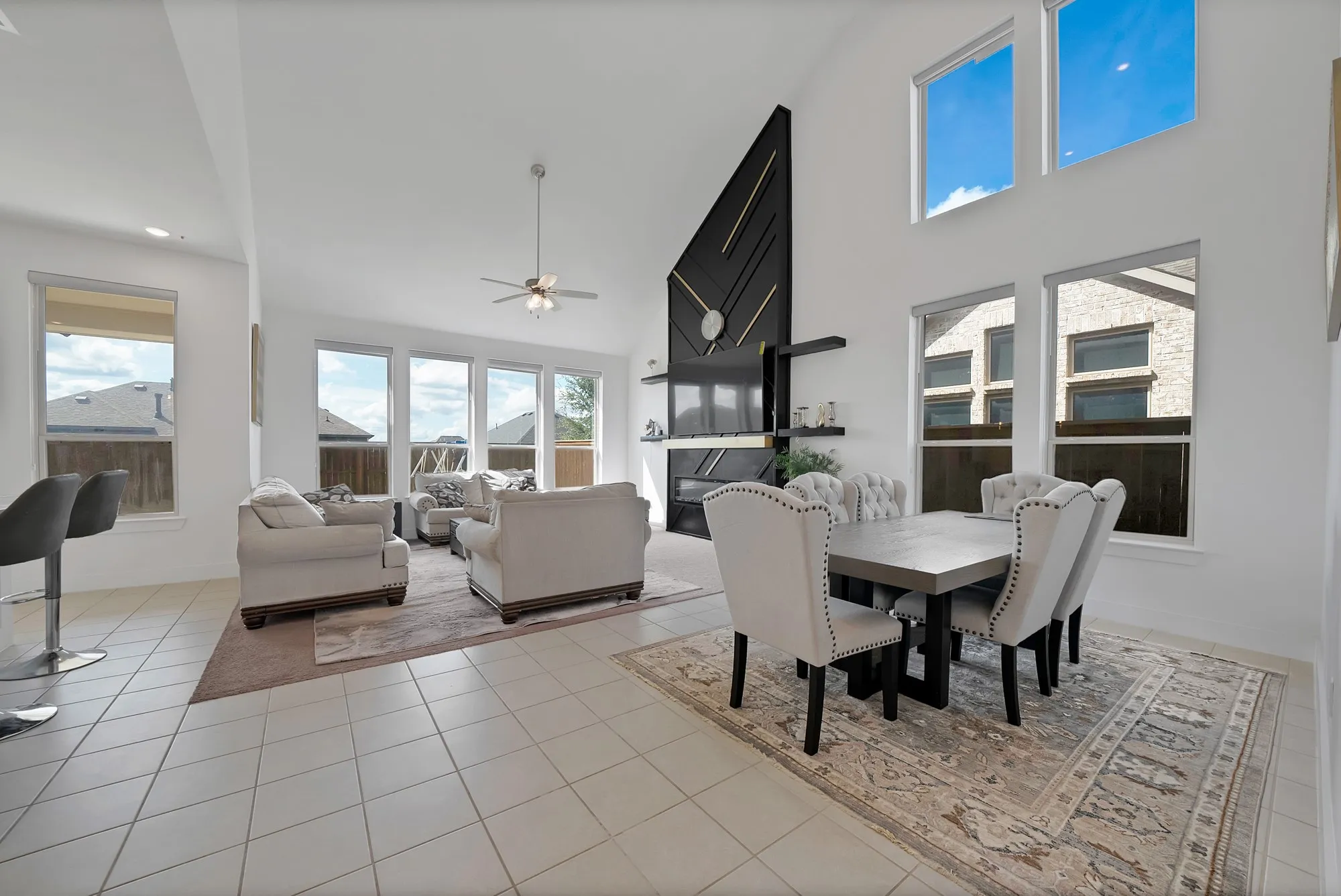 Vaulted ceiling, recessed lighting, tile flooring, and multiple windows