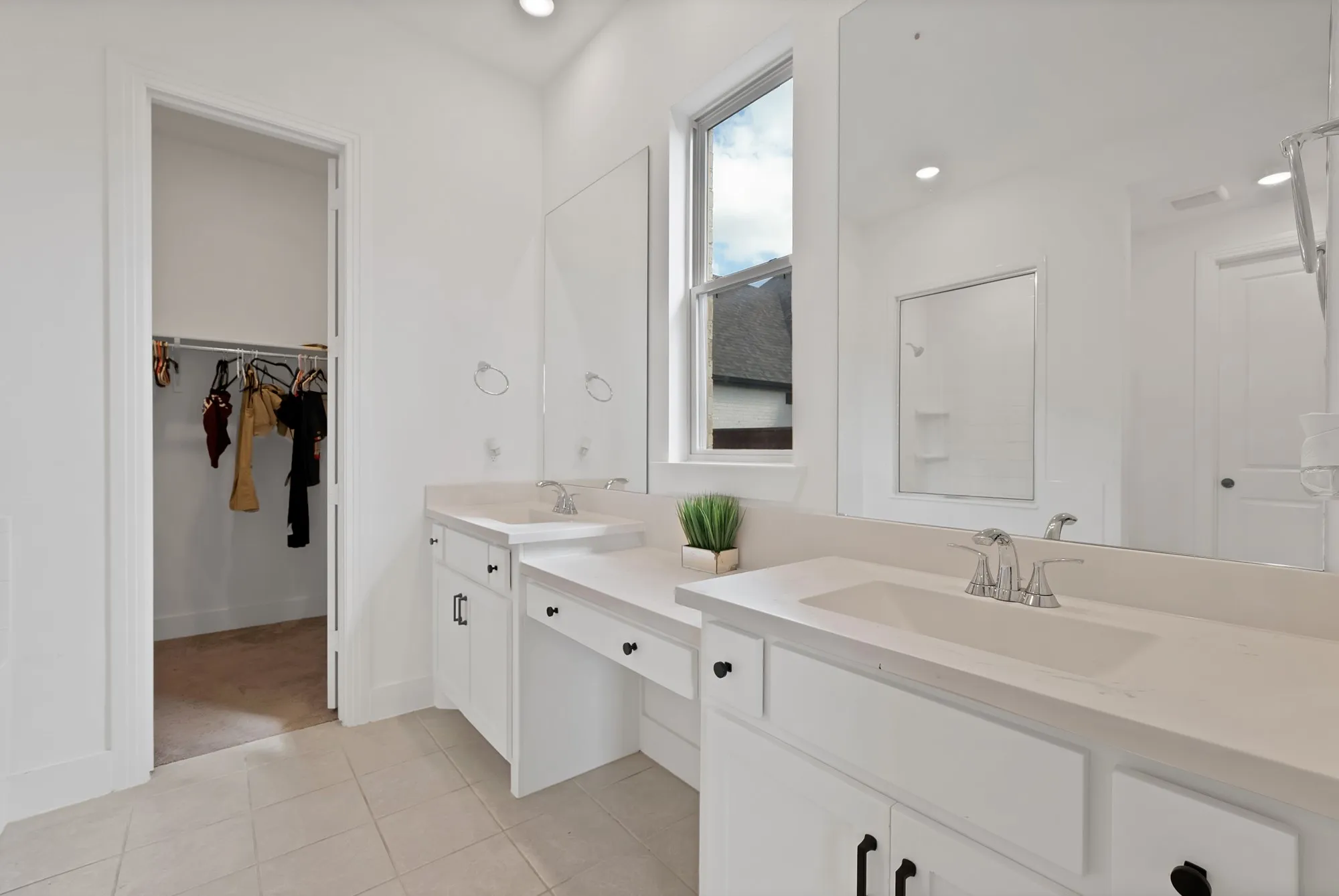 Dual vanity with integrated sinks, white cabinetry, and light-toned countertops