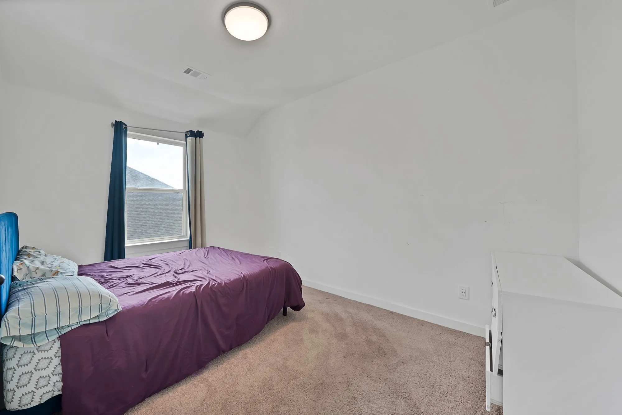 Neutral colored carpeting complemented by white walls