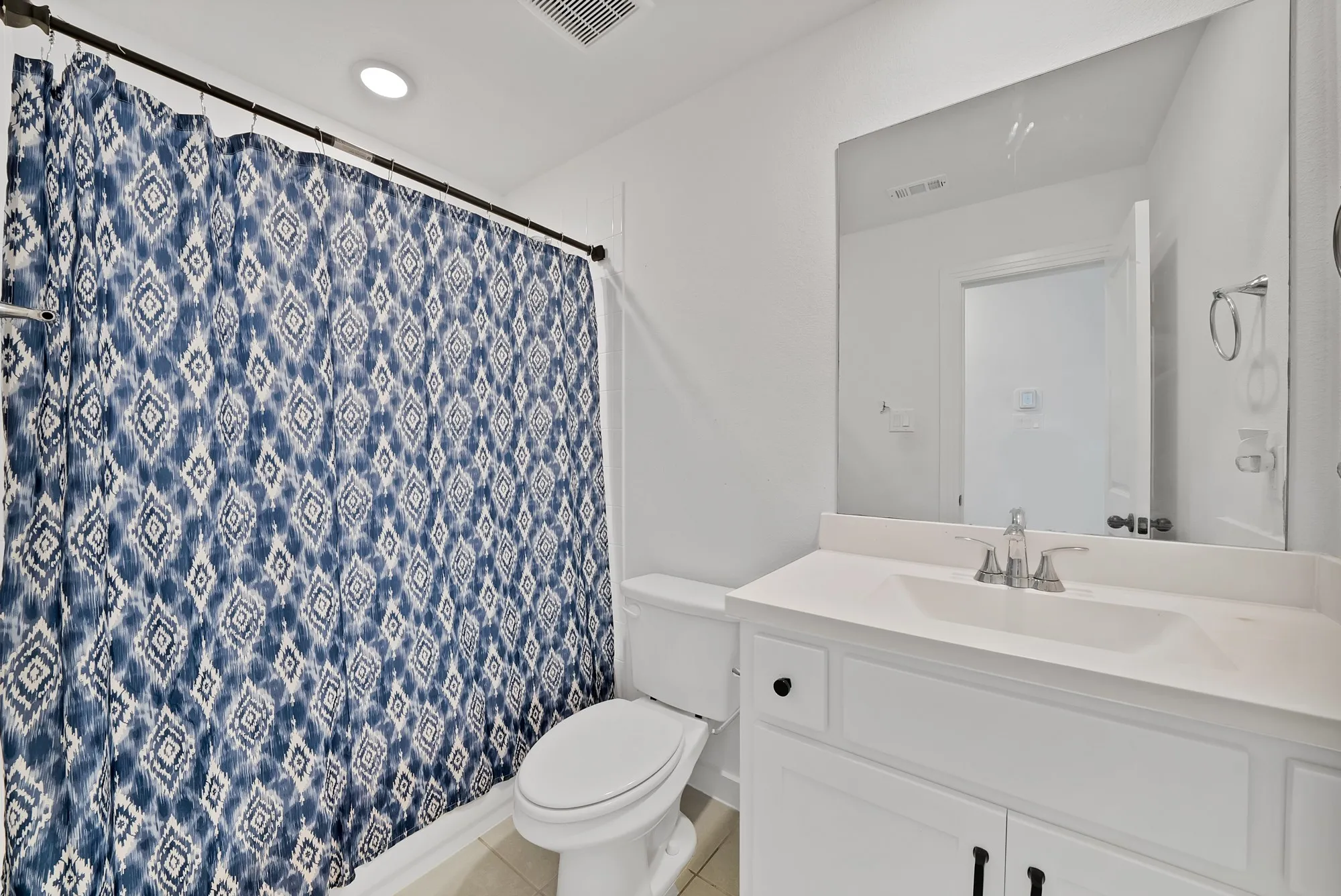 White vanity with a single basin sink, chrome faucet, and integrated countertop