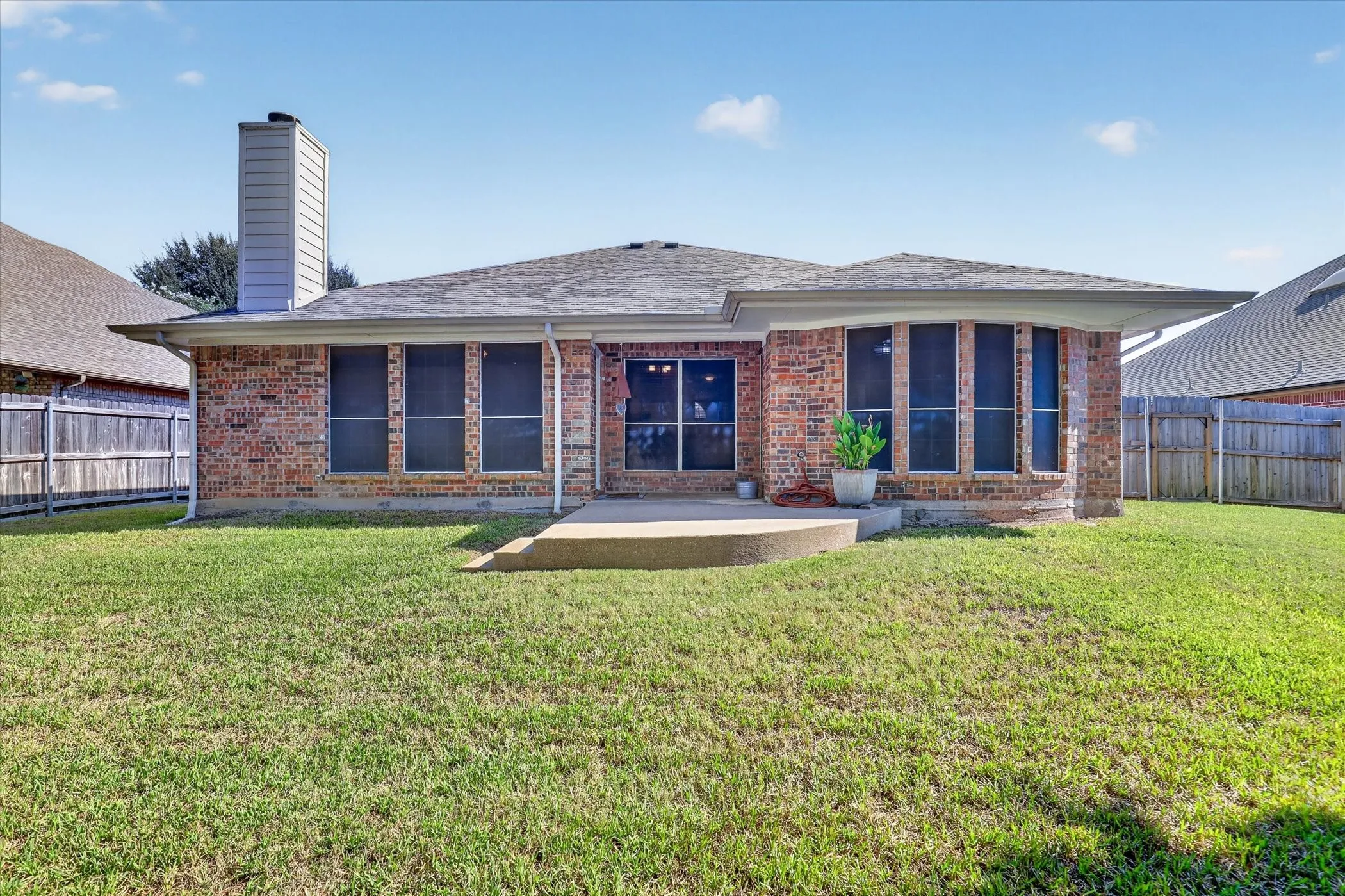 Brick exterior with a covered patio and a gabled roof