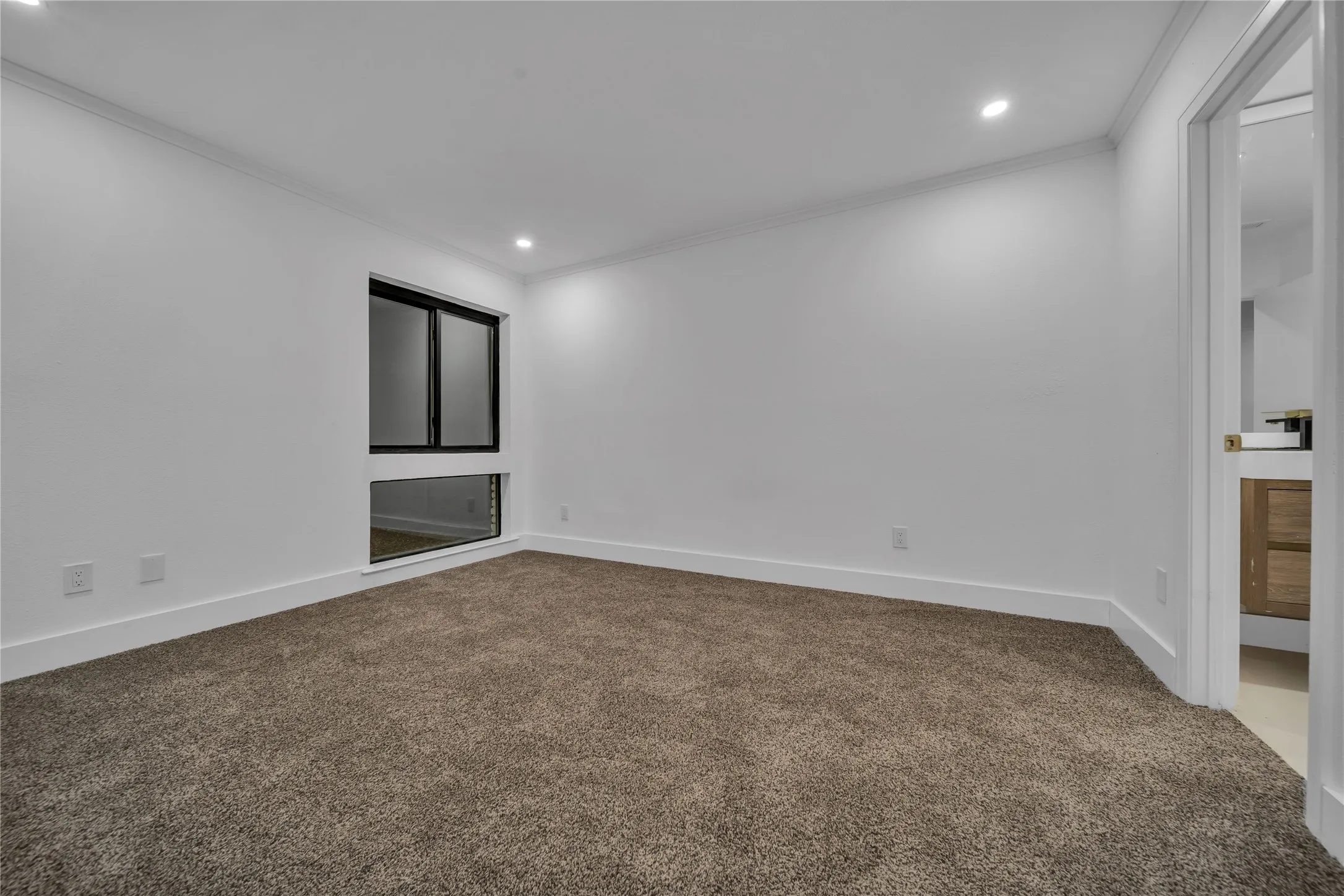 Spare room featuring carpet flooring and ornamental molding