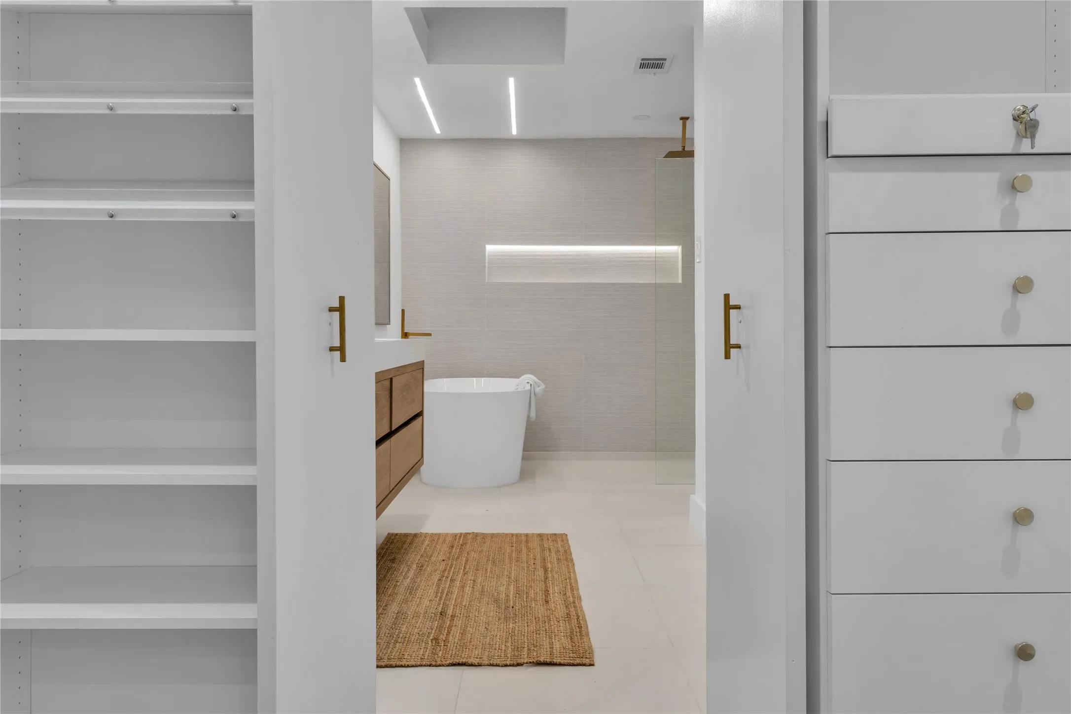 Bathroom featuring tile patterned floors, vanity, separate shower and tub, and tile walls