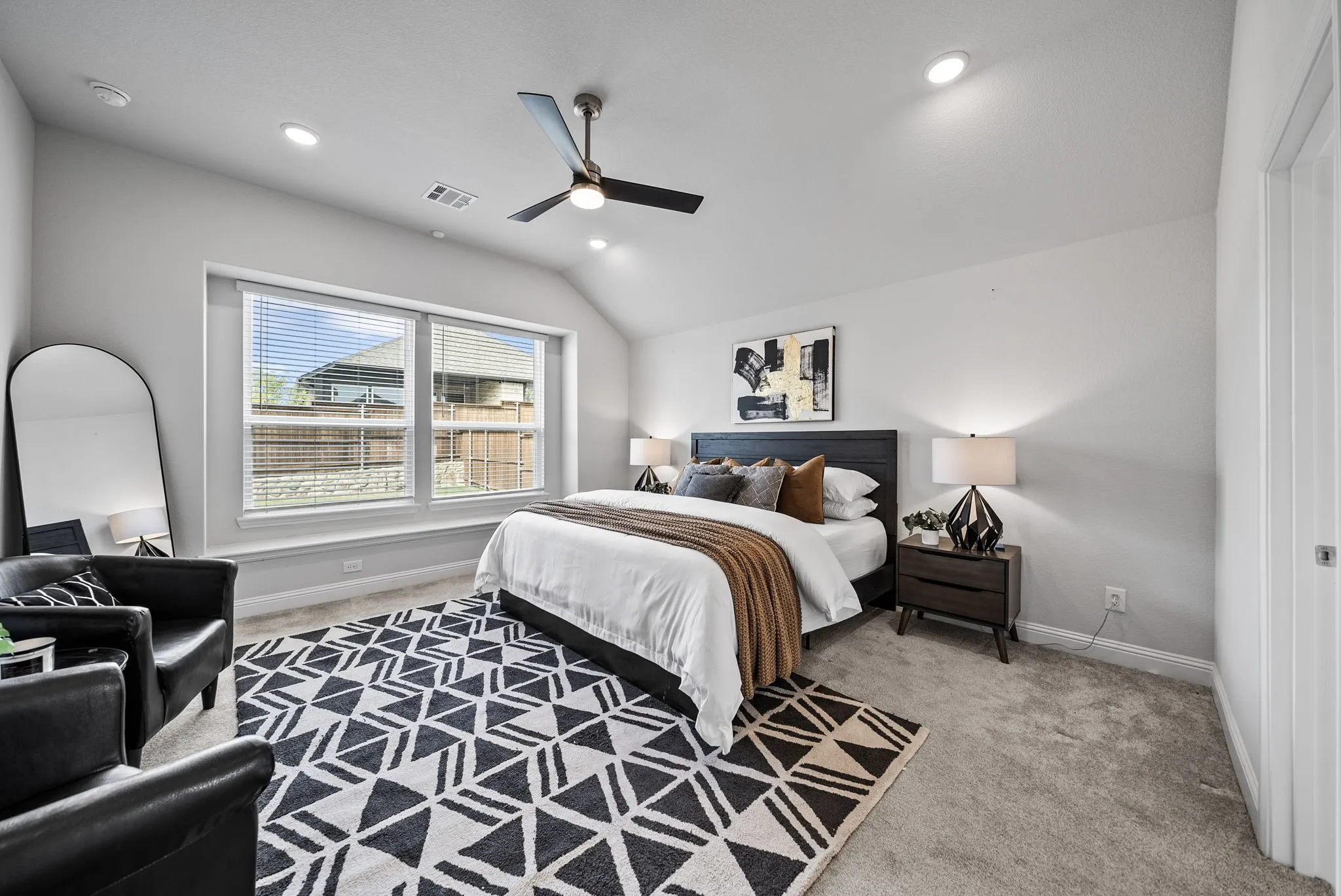 Vaulted ceiling with a ceiling fan and recessed lighting