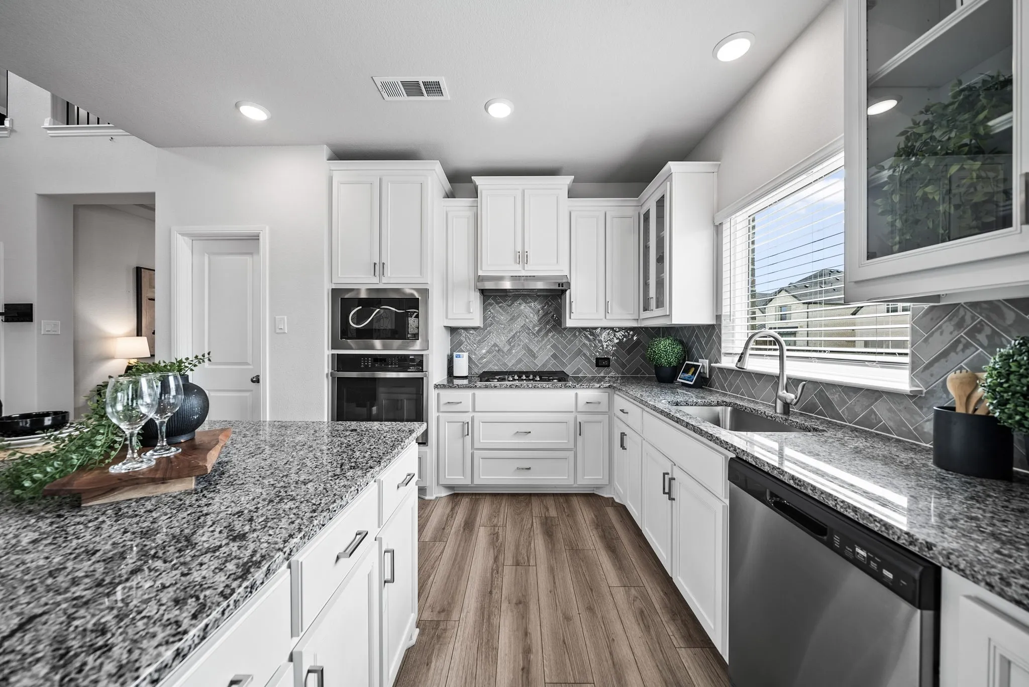 White cabinetry with stainless steel appliances and undermount sink