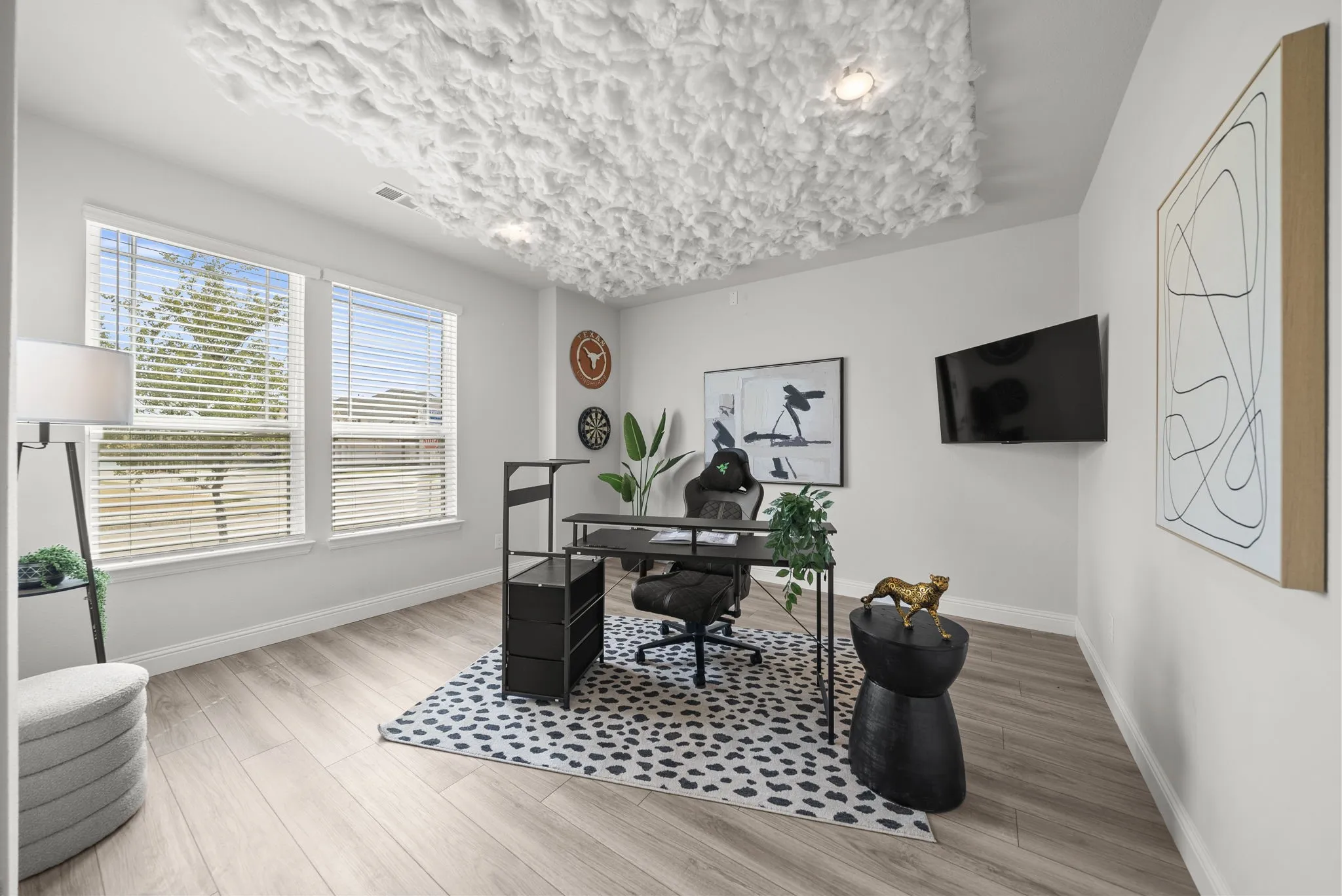 Recessed lighting, light wood-finish flooring, two large windows, white walls, and a distinctive textured ceiling