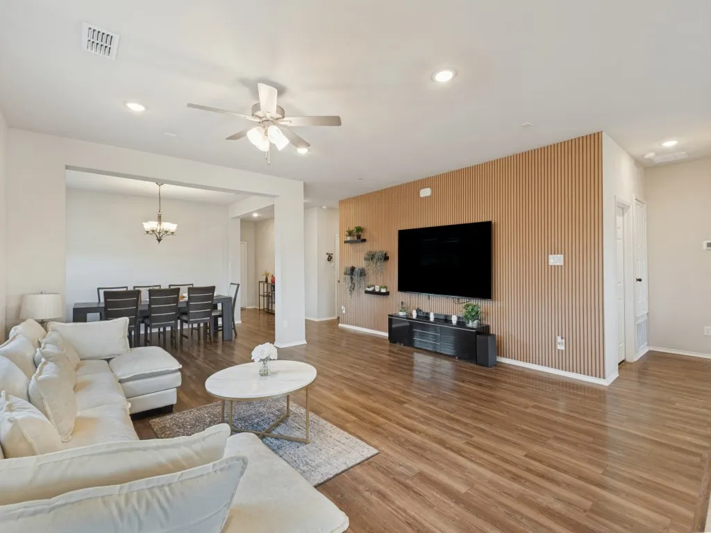 Wood-finish flooring throughout, recessed lighting, and a ceiling fan