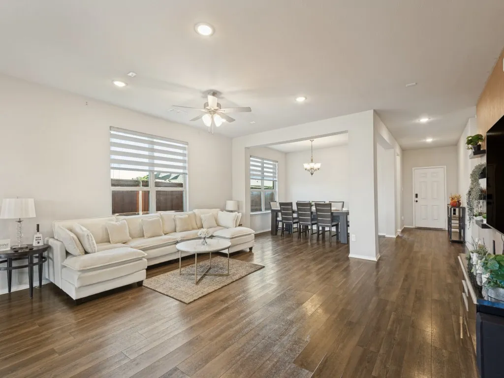 Wood-finish flooring throughout, recessed lighting, and a ceiling fan