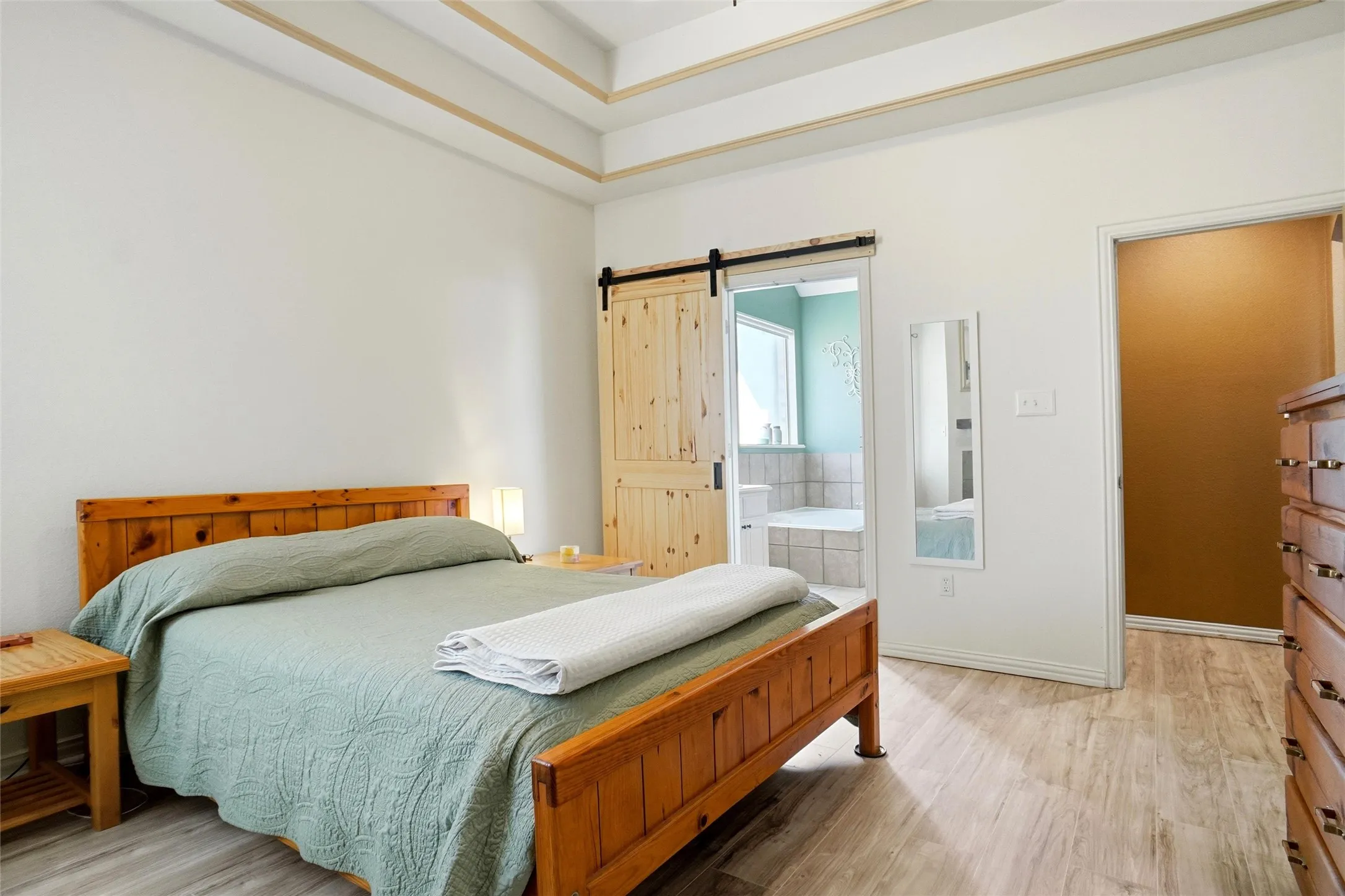 Look at that cute barn door to the primary ensuite bath!