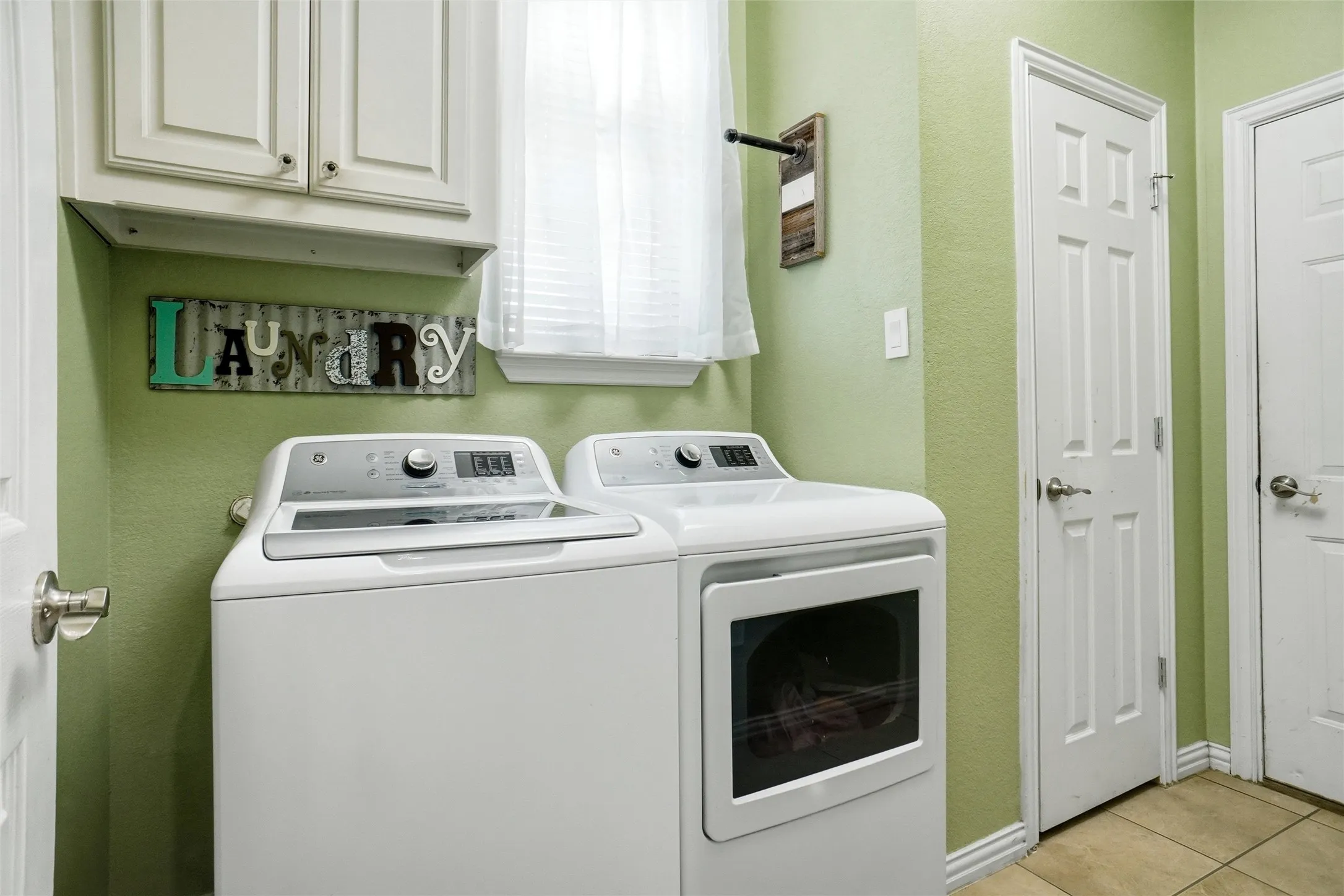 Full washer/dryer space with storage.
