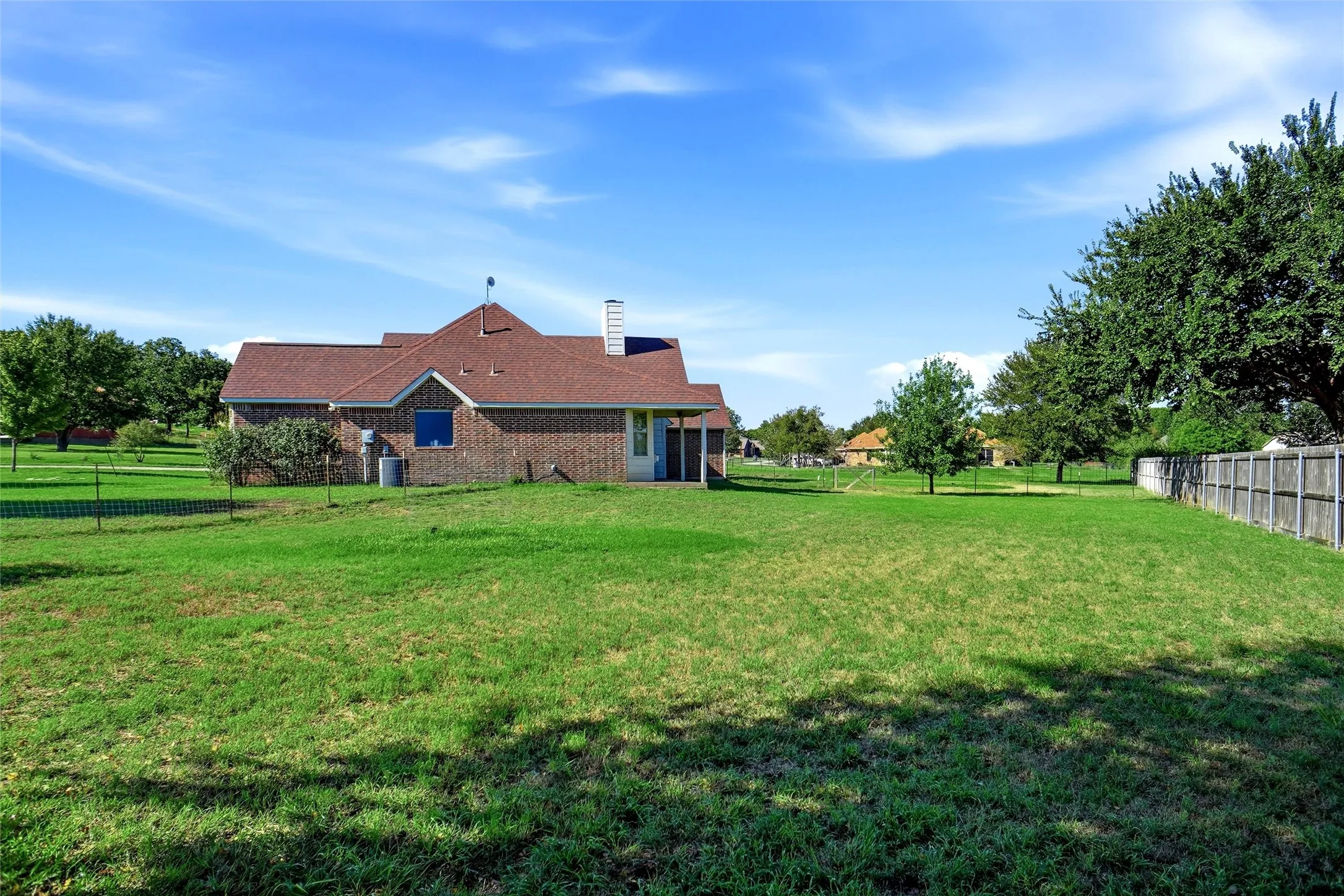 Side view of home; front of structure is to the left in this photo. Lots of room to roam!