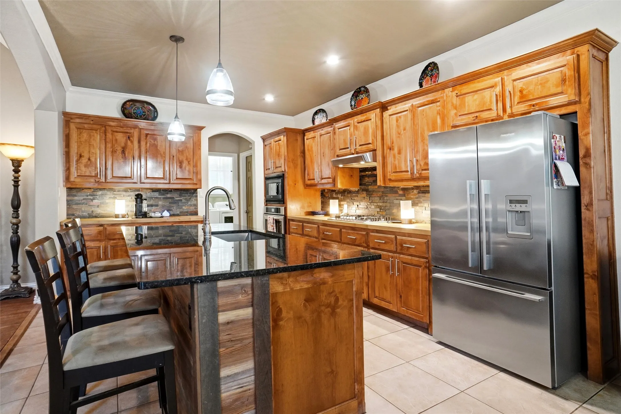 View of kitchen from breakfast, lovely burled hardwoods, with granite and butcherblock tops. Refrigerator can convey with appropriate offer!