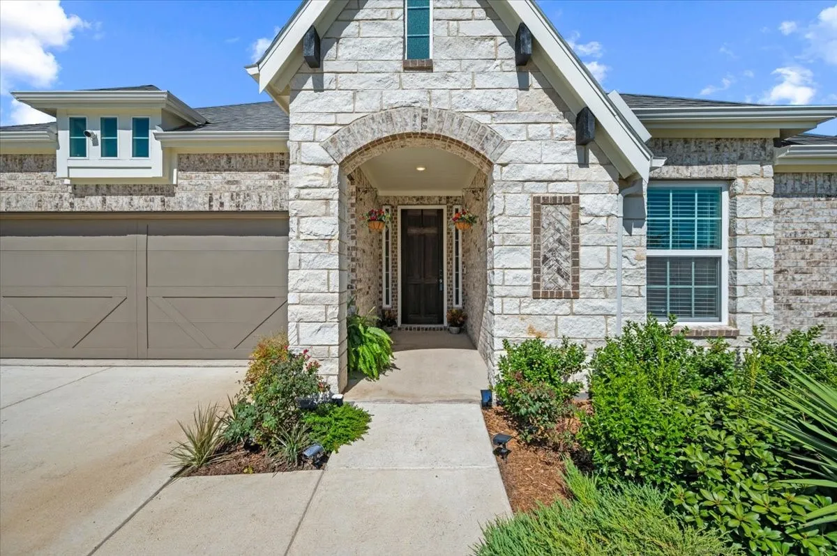 Stone and brick exterior with an arched entryway