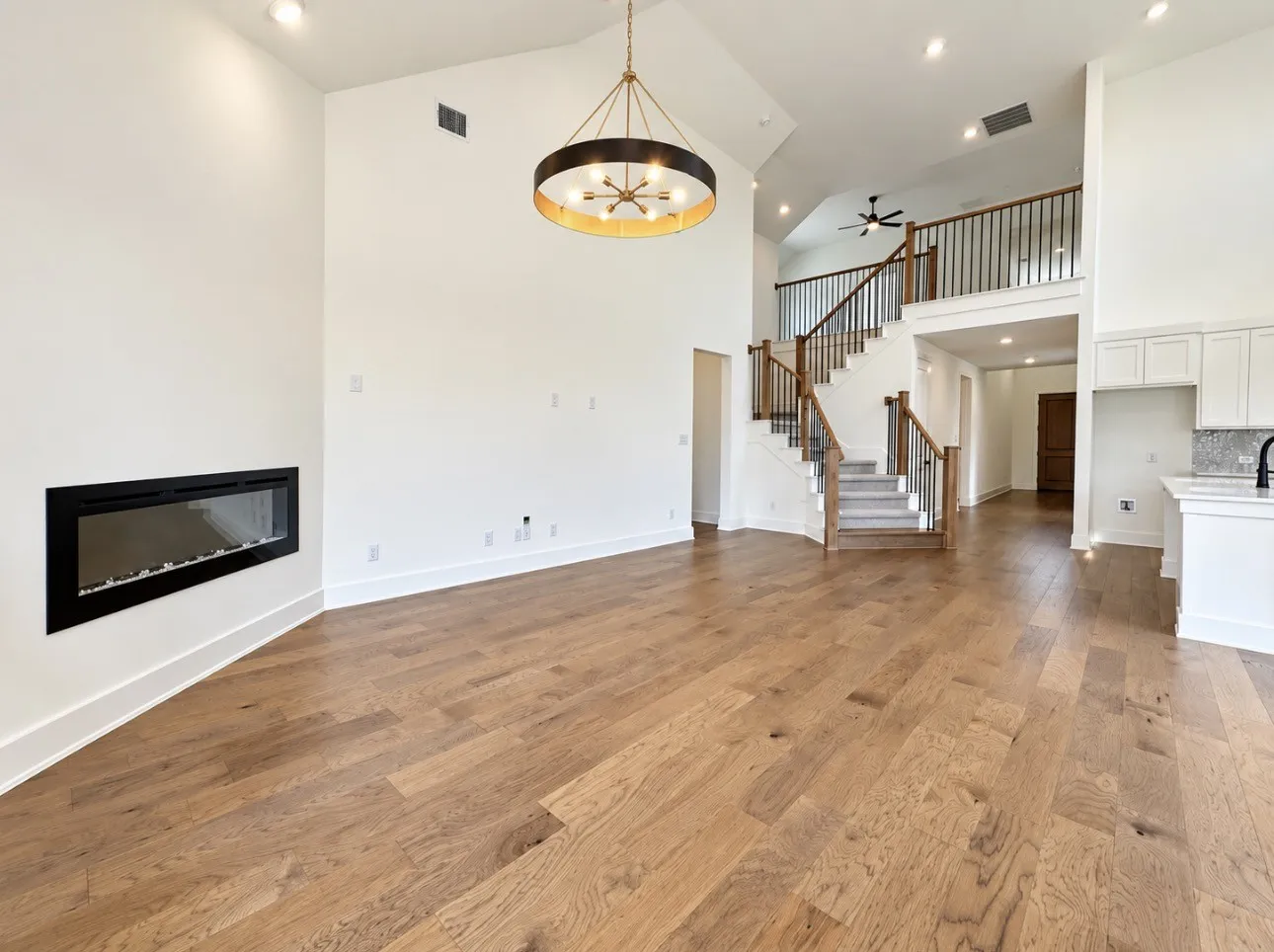 Wood-finish flooring throughout, with a linear fireplace