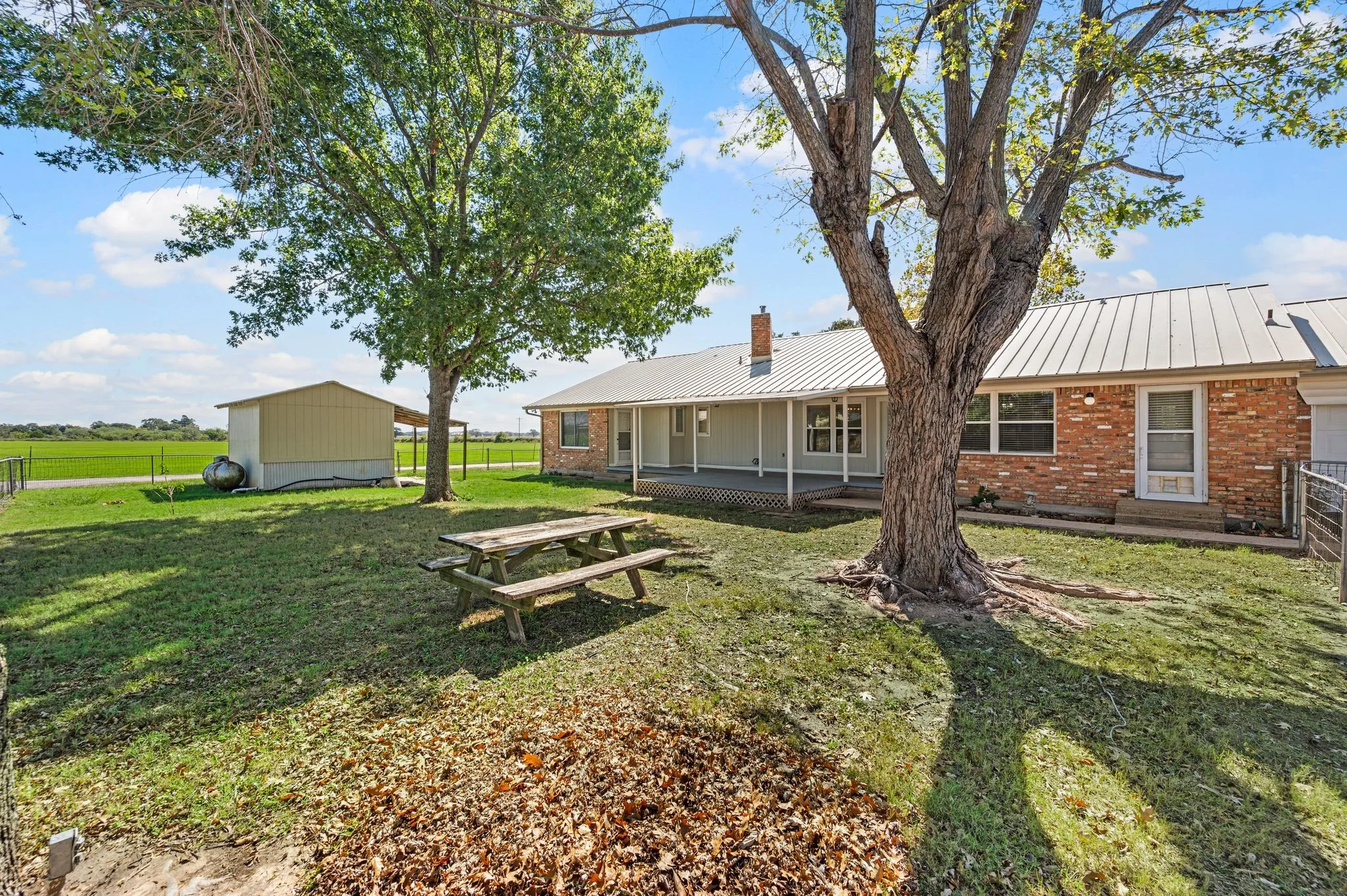 Backyard with covered patio and gardening shed
