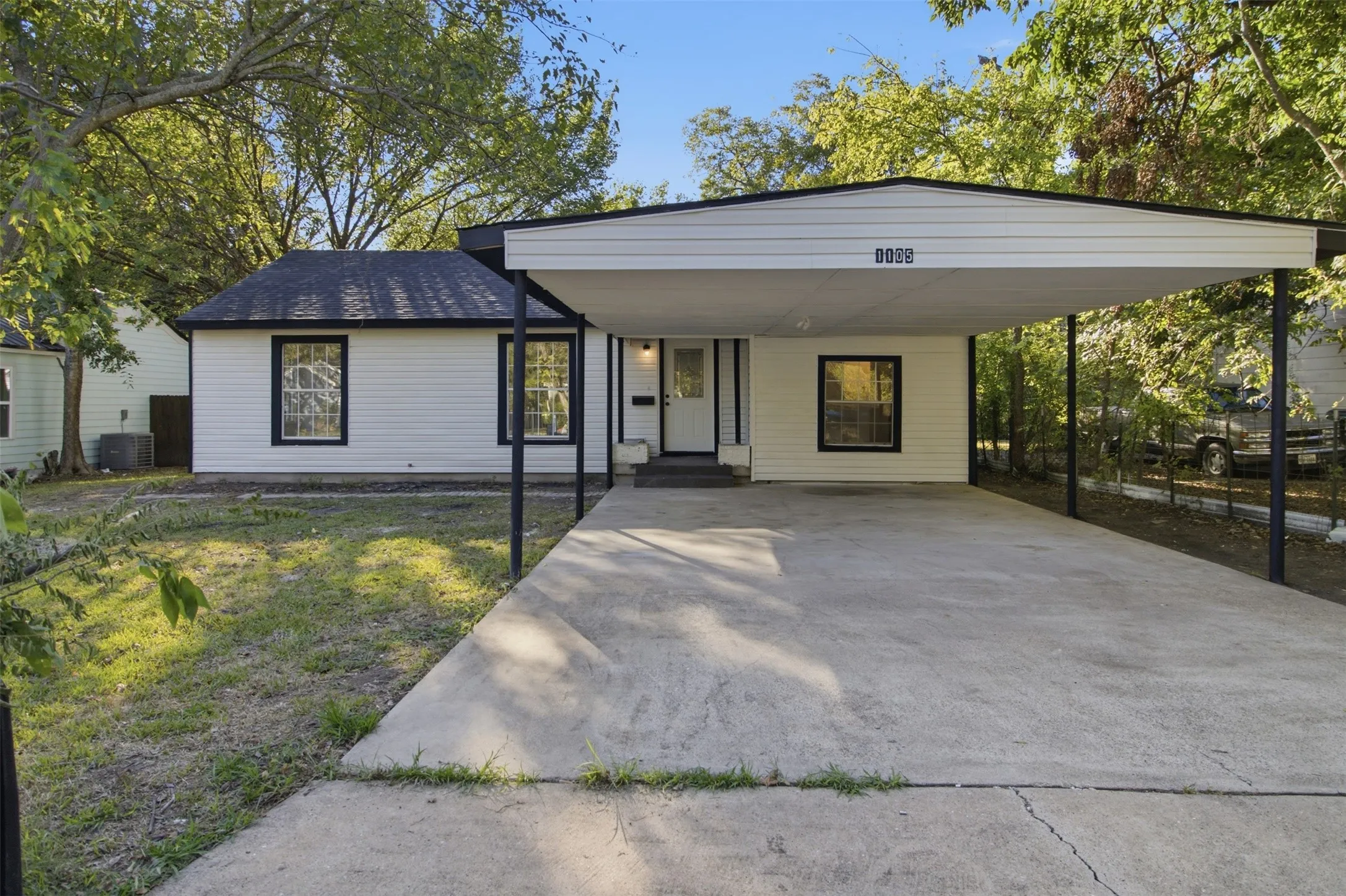 White exterior siding with black trim windows