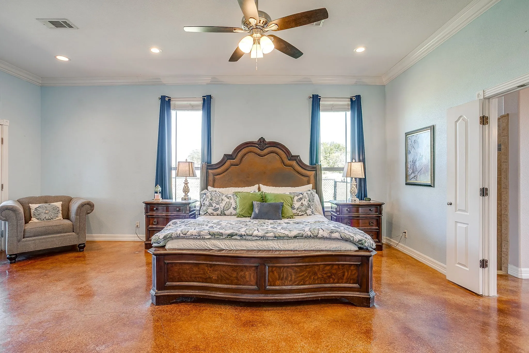 Spacious room featuring wood-finish flooring, high ceilings with crown molding, recessed lighting, and a ceiling fan