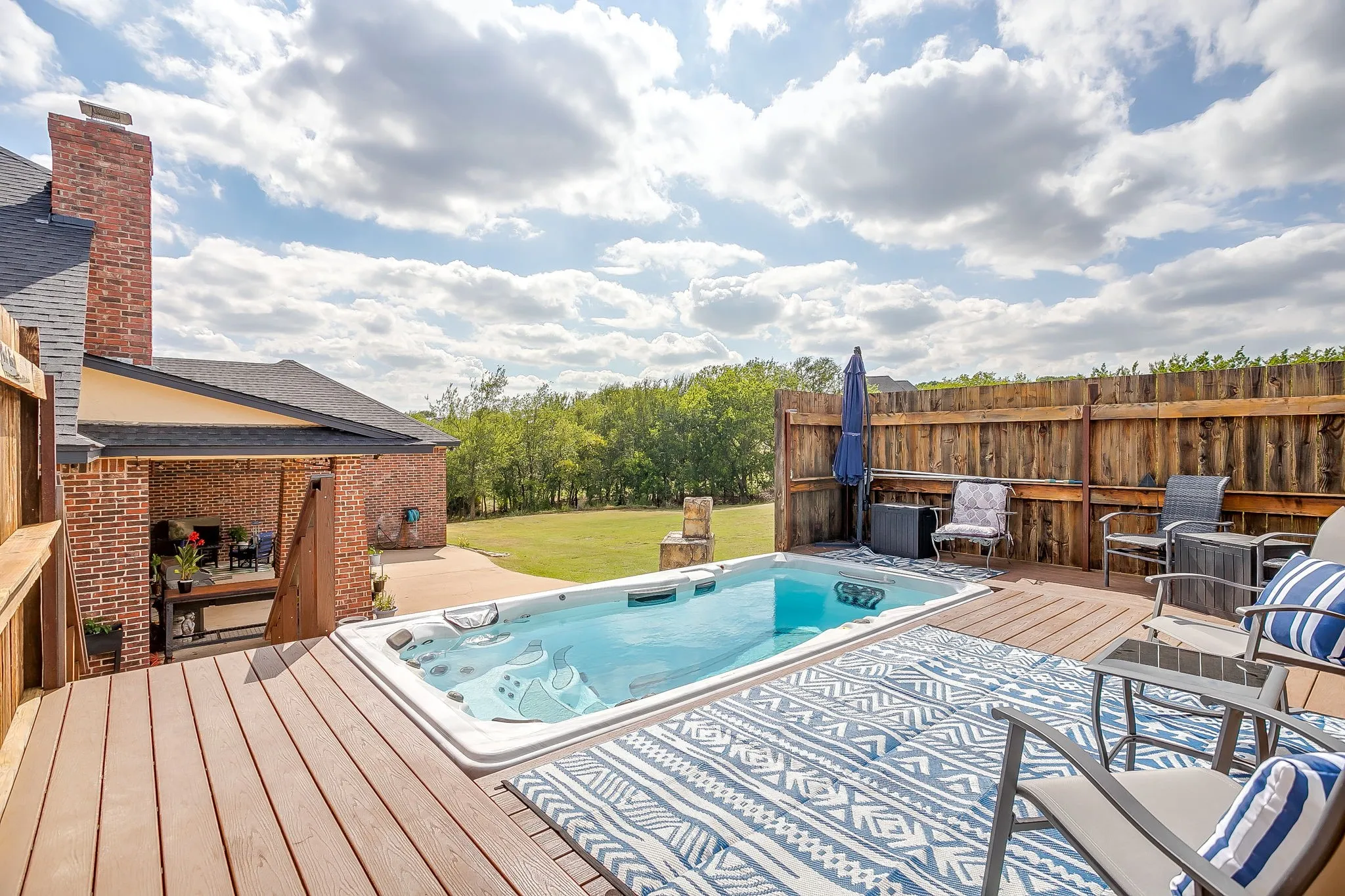 Expansive grounds featuring open pastureland with mature tree lines bordering the property