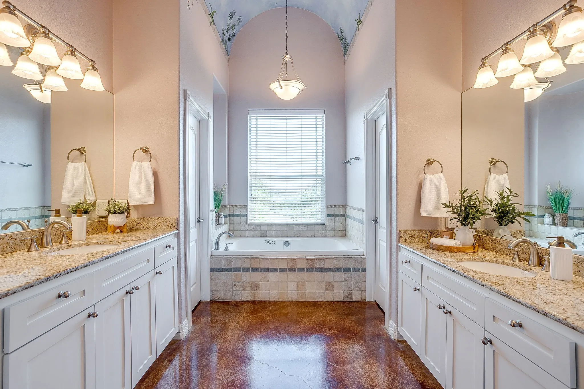 Dual vanities featuring granite countertops and undermount sinks