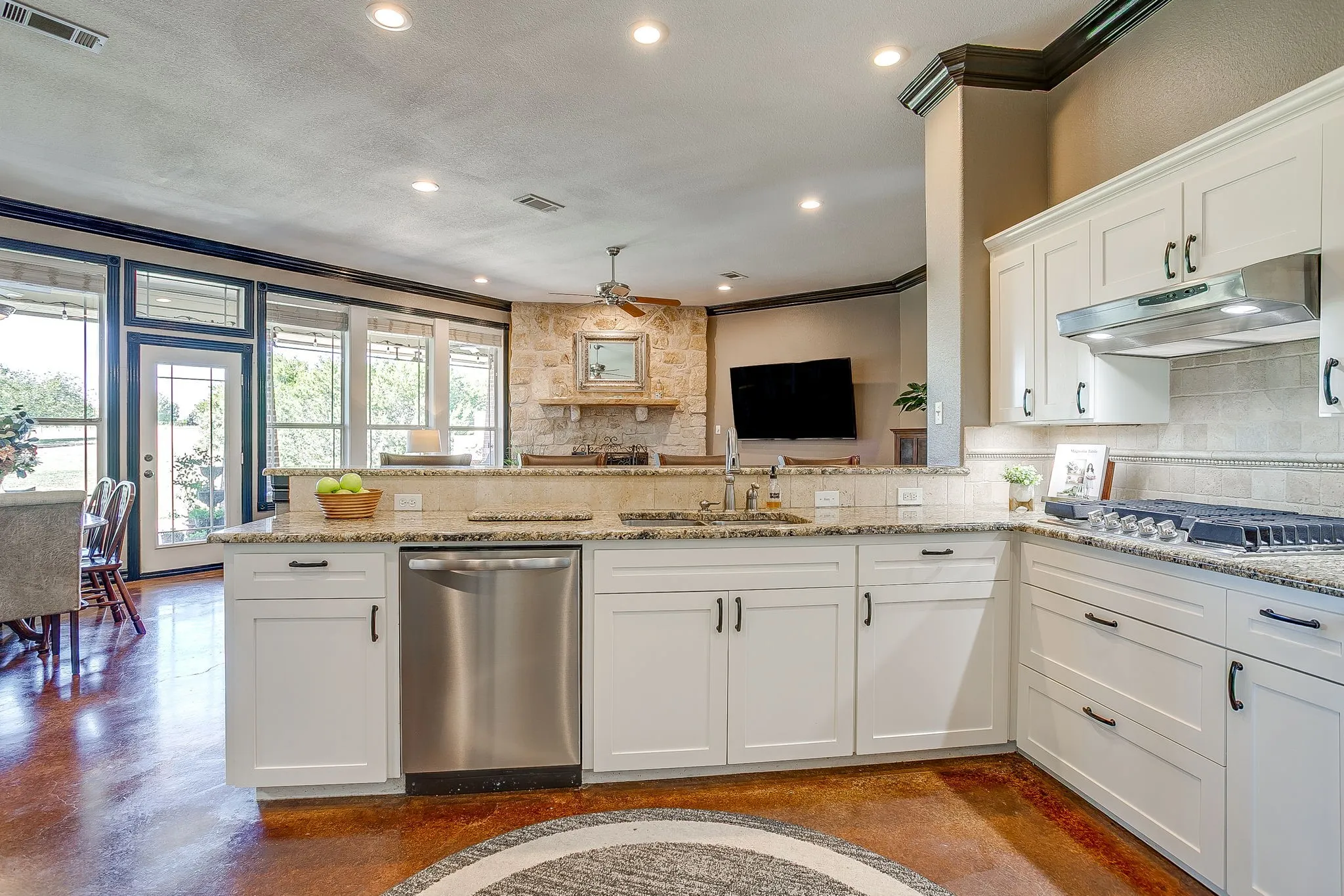 Kitchen featuring white shaker cabinetry, granite countertops, stainless steel appliances, and a stone backsplash
