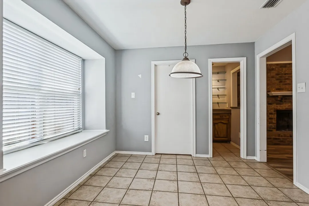 Tile flooring and a prominent window with a deep sill