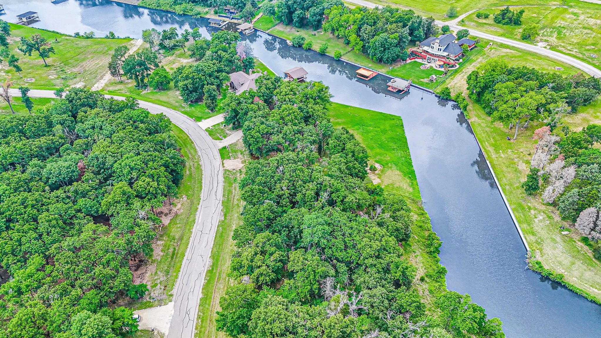 Birds eye view of property with a water view
