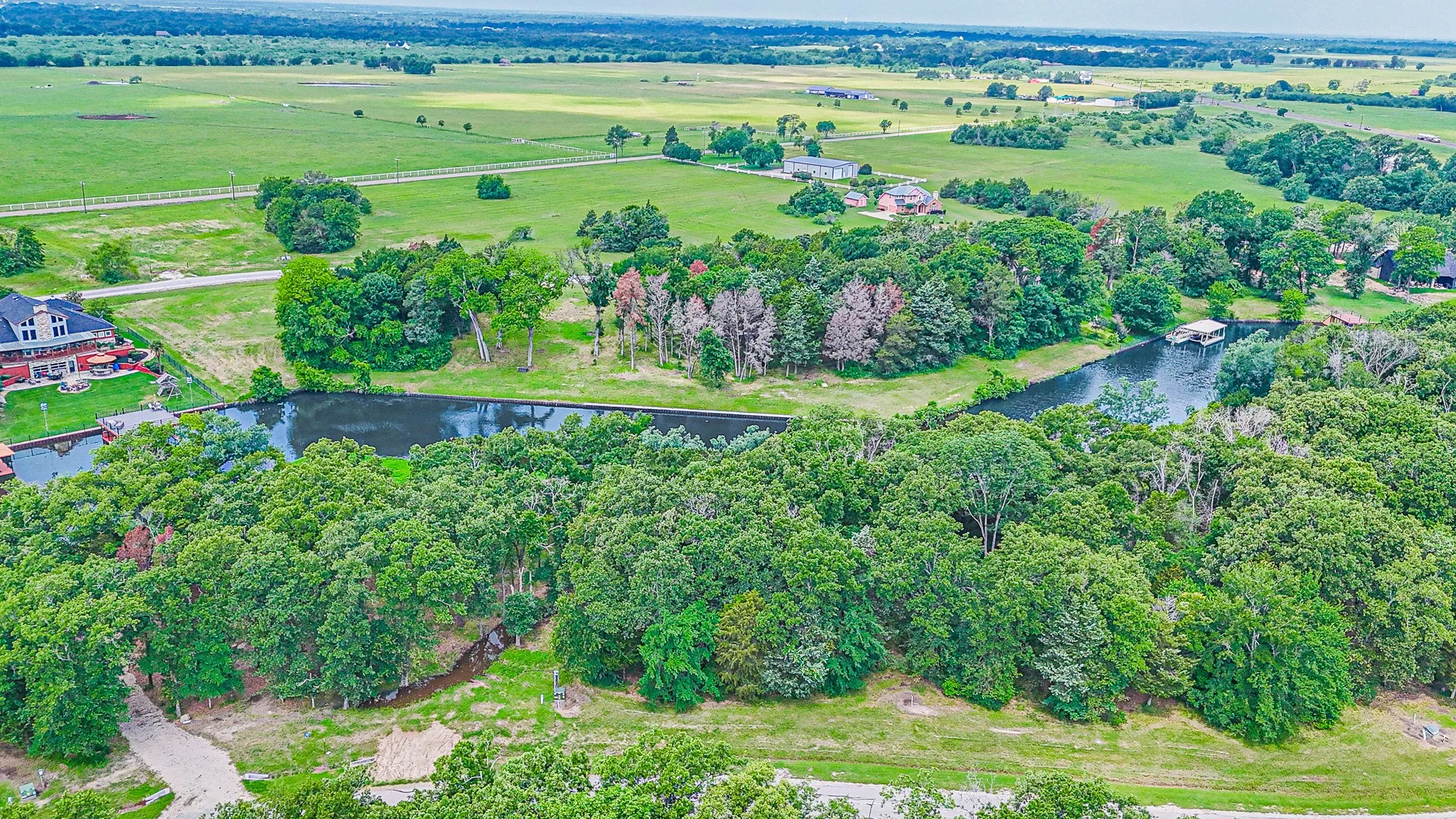 Birds eye view of property with a rural view and a water view