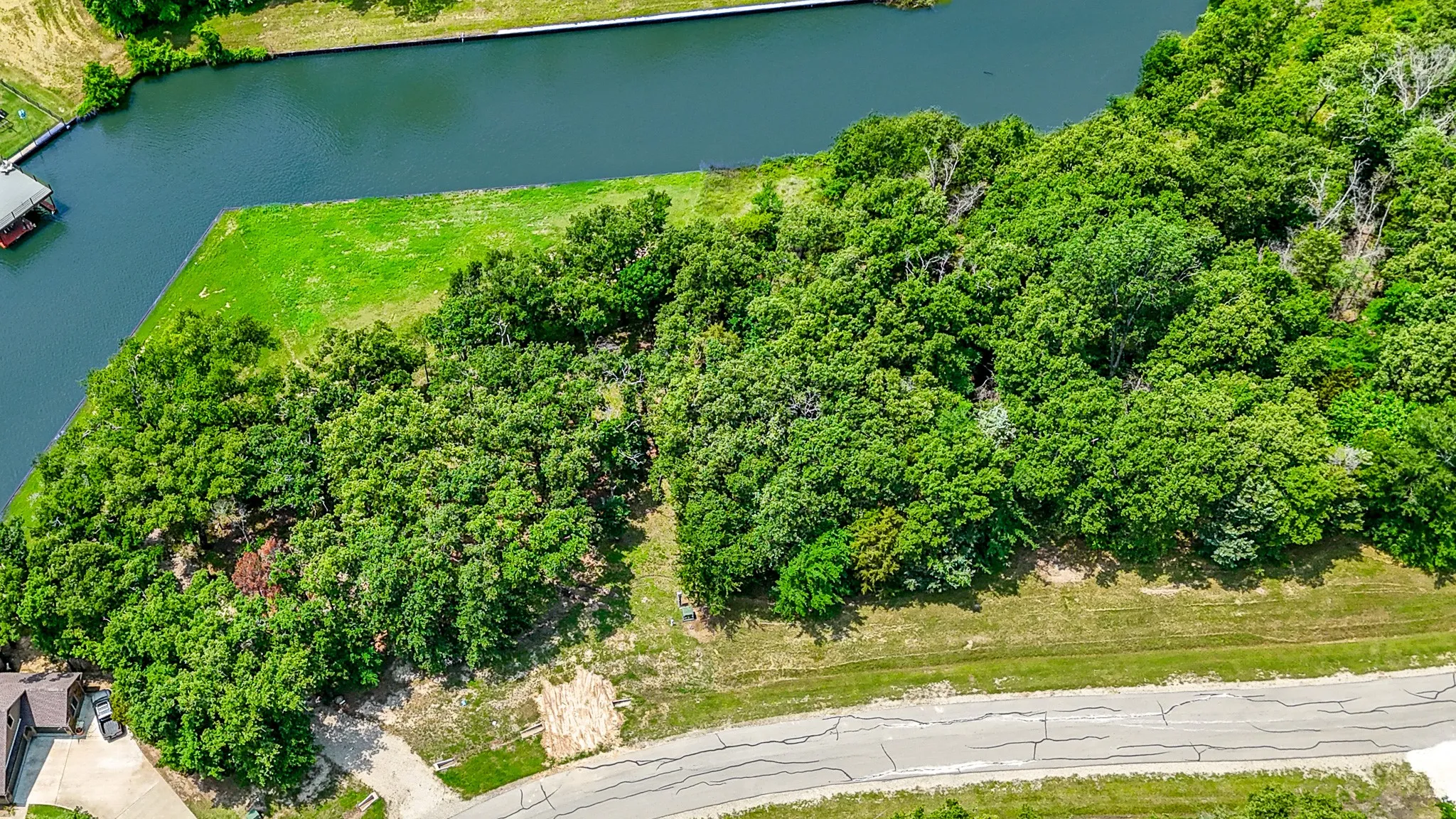 Birds eye view of property with a water view