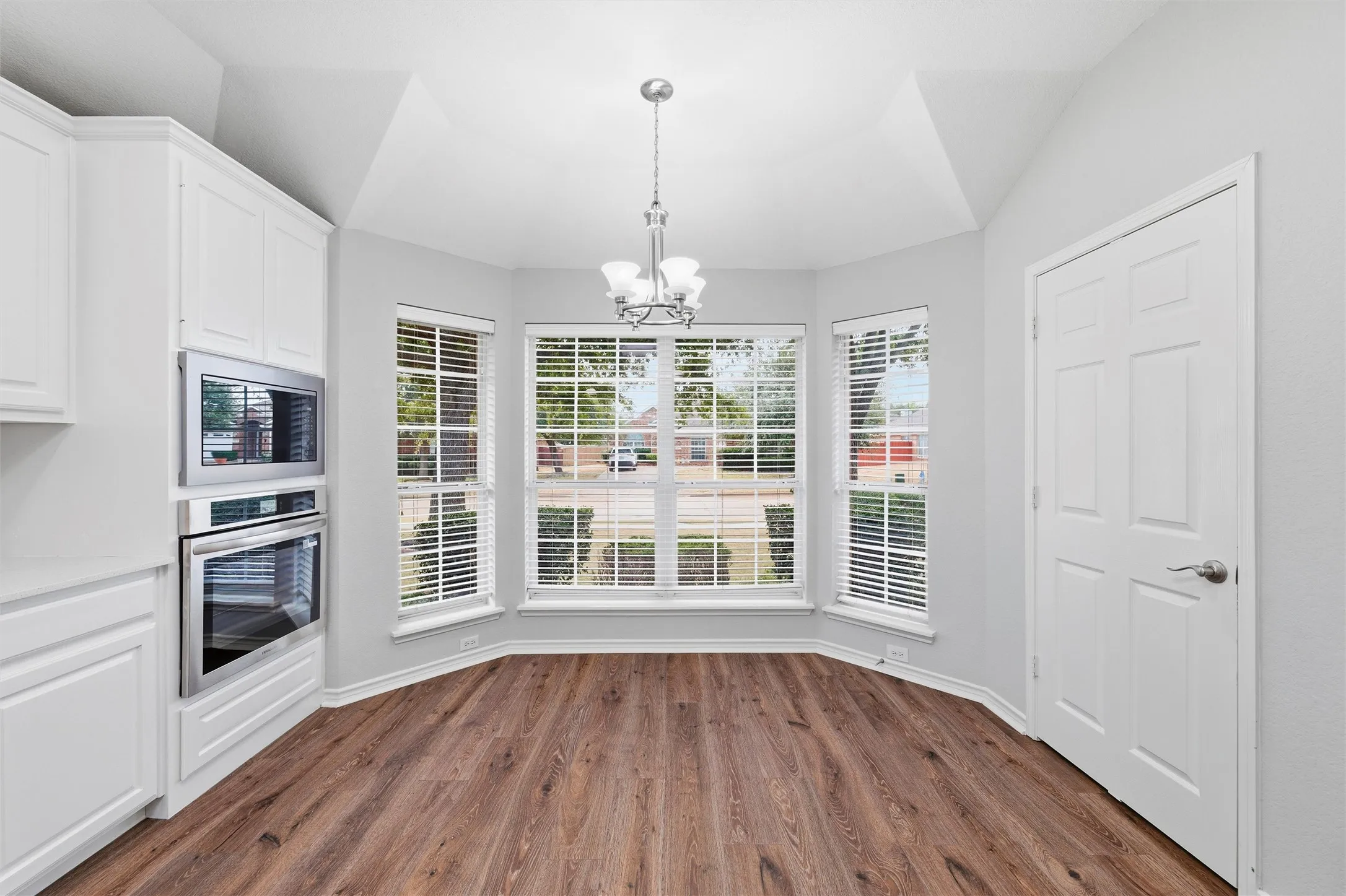 Sunny eat-in area with bay-style windows, providing a comfortable spot for everyday dining while overlooking the front of the home.