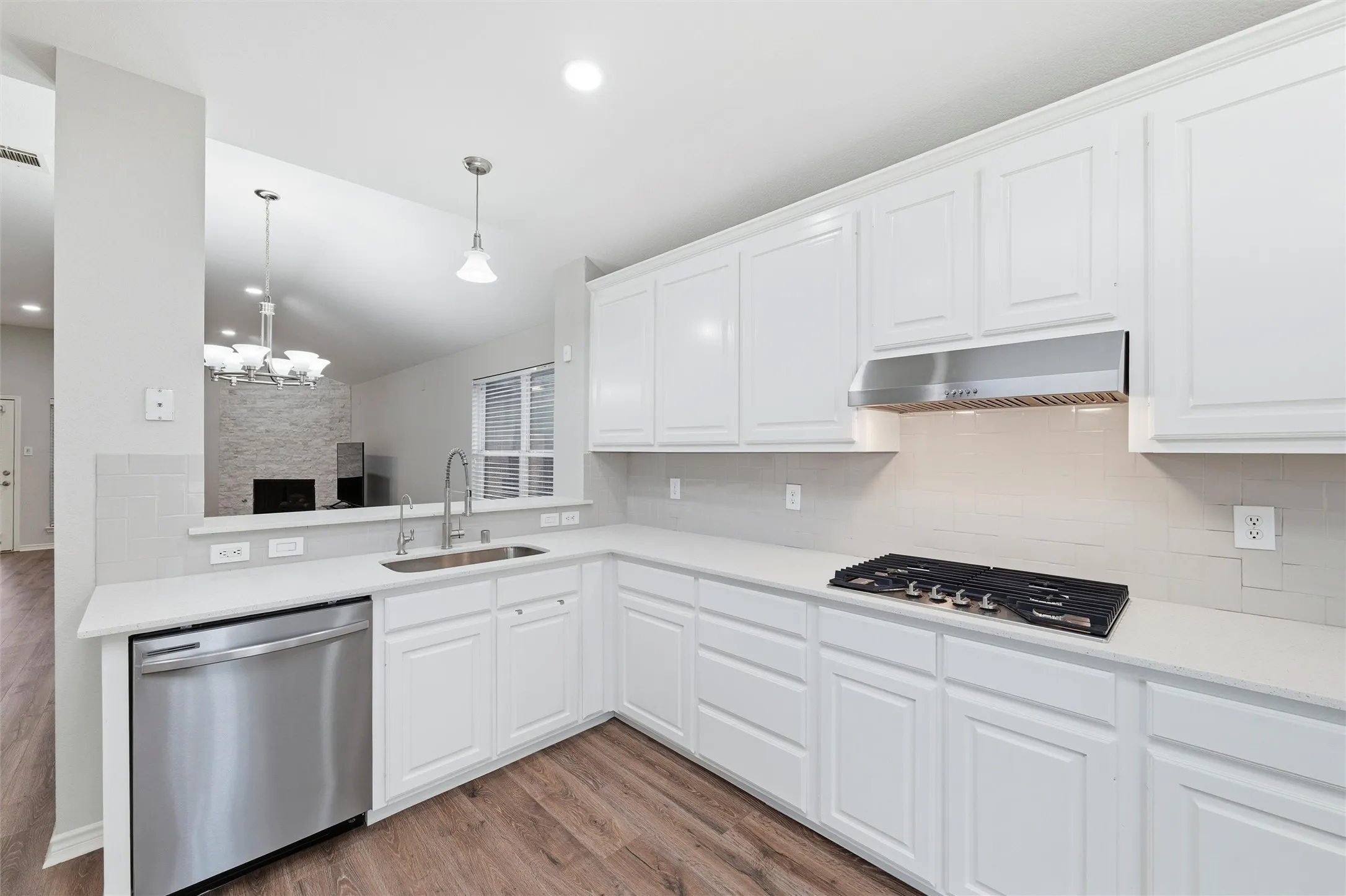 Thoughtfully updated workspace featuring a new sink, quartz counters, stainless steel dishwasher, and under-sink reverse osmosis system.