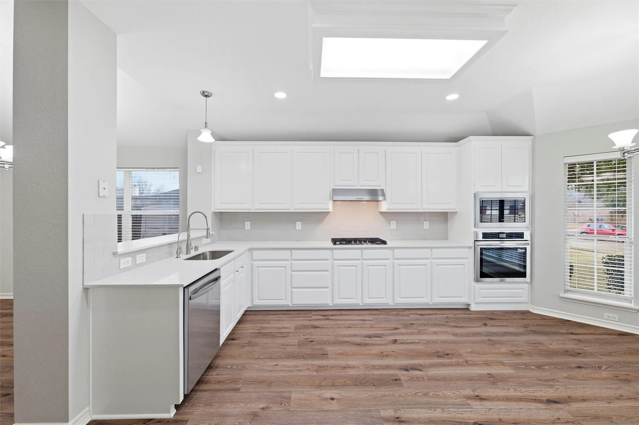 Enjoy easier meal prep in this bright, updated kitchen featuring a gas cooktop, built-in oven and microwave, updated hardware, and clean, contemporary finishes throughout.