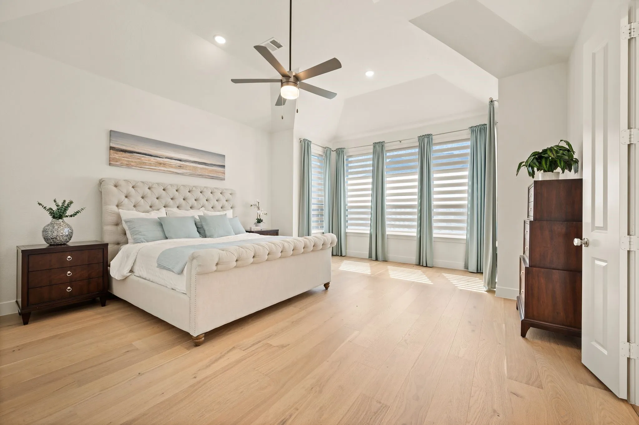 Wood-finish flooring, recessed lighting, and a sloped ceiling with a ceiling fan