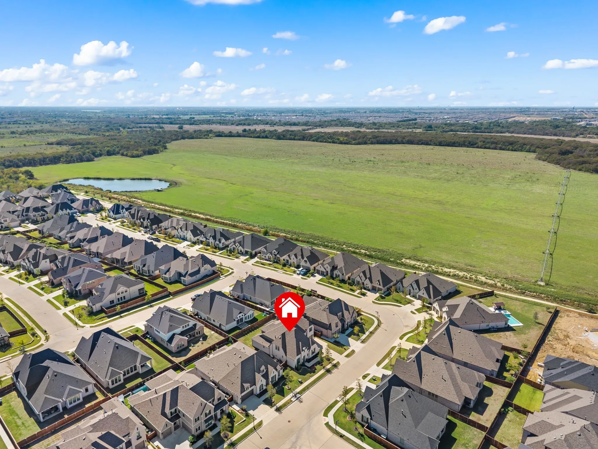 Residential development featuring a pond and expansive green space