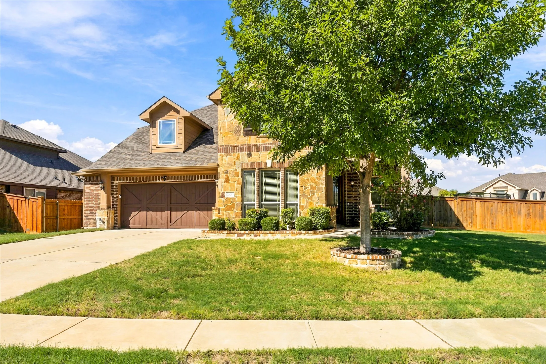 Attractive front elevation surrounded by mature landscaping.