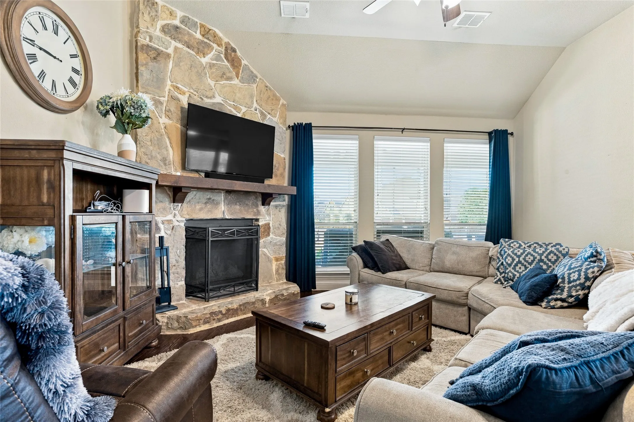 Inviting living space featuring a cozy fireplace and abundant natural light.