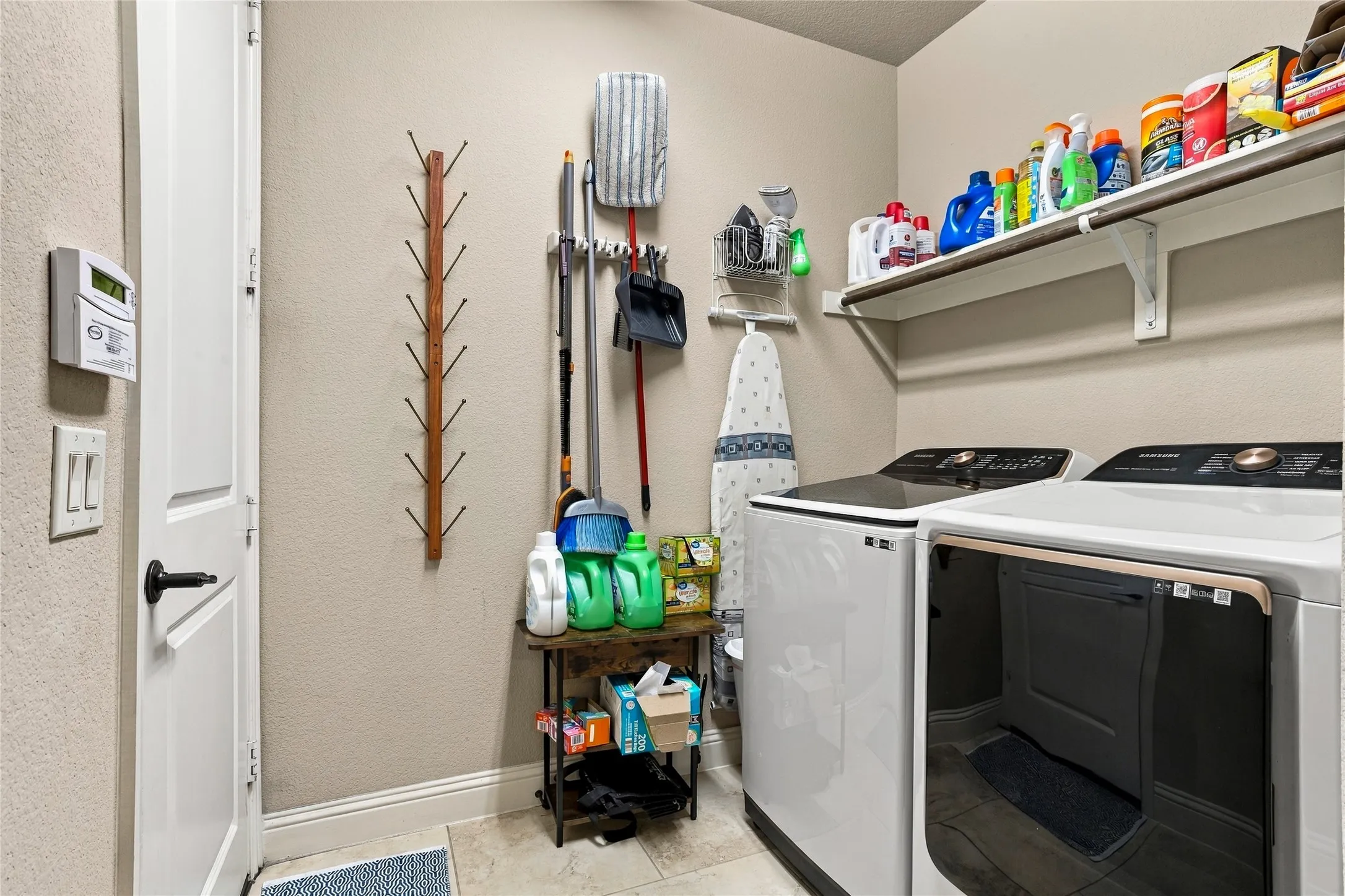 Functional utility room with additional storage and workspace.