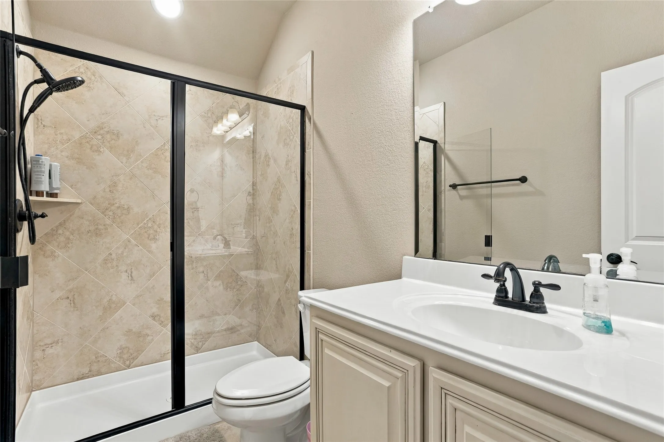 Full bathroom featuring a walk-in shower and spacious vanity.