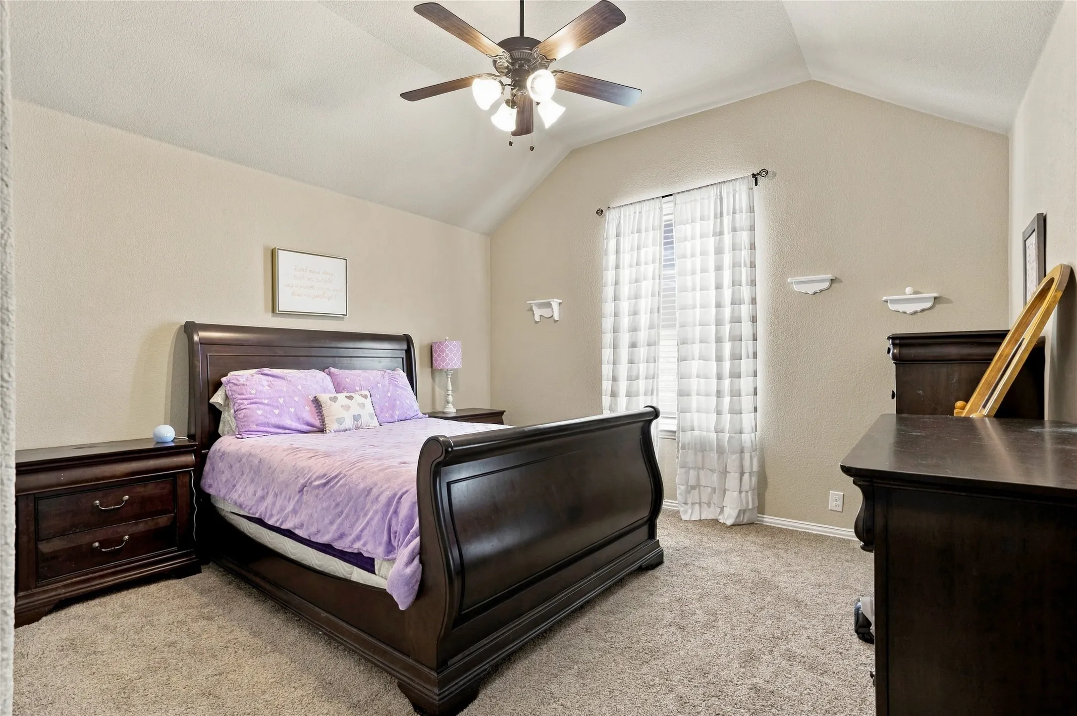 Additional bedroom with vaulted ceiling and abundant natural light.