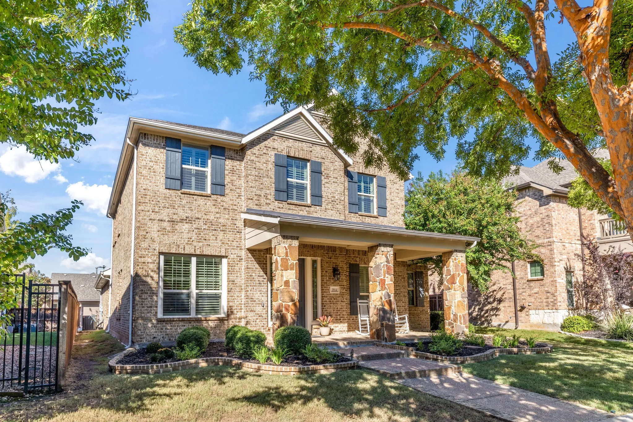 Brick exterior with stone accents and a covered front porch