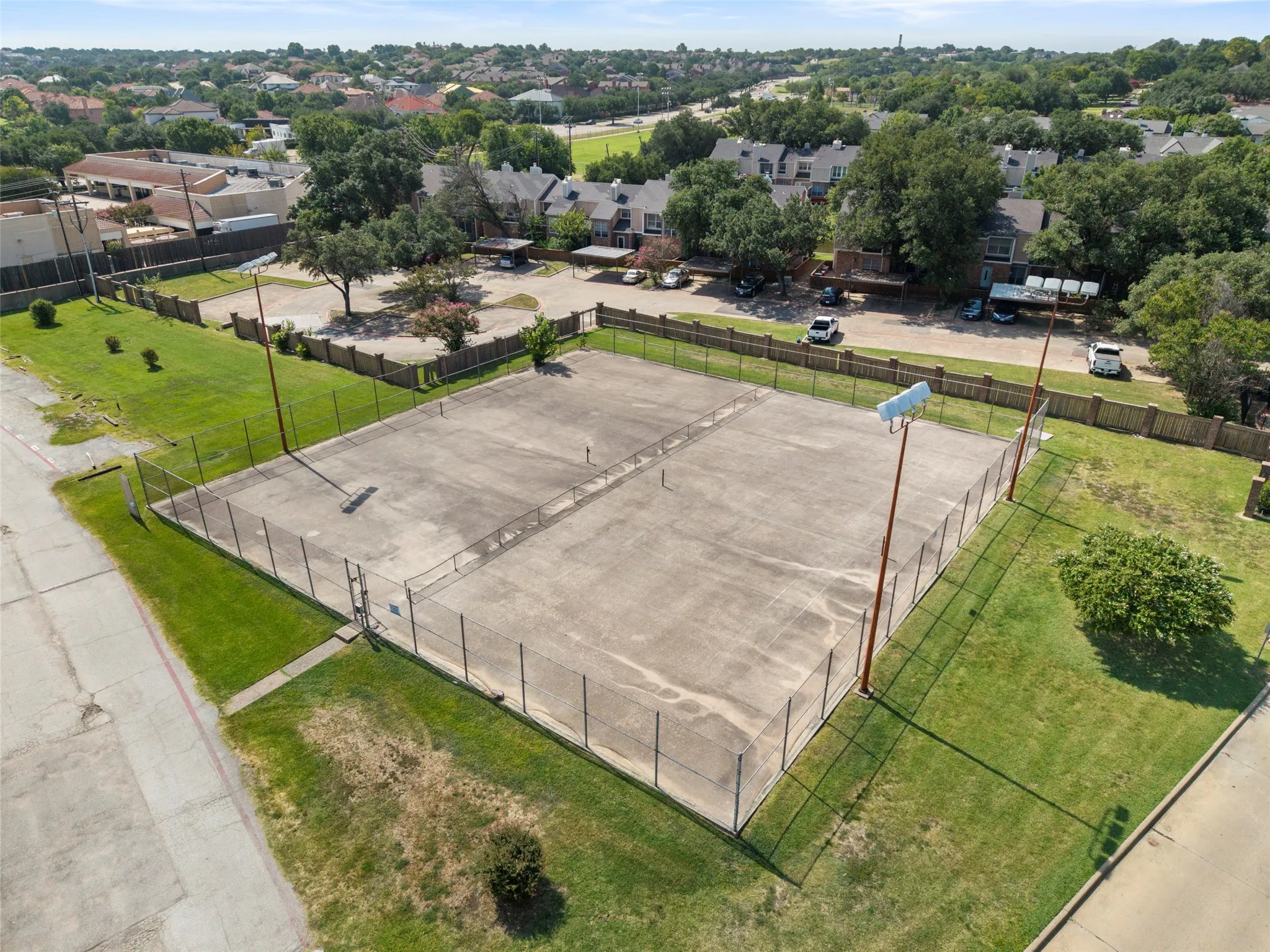 Concrete court with perimeter fencing