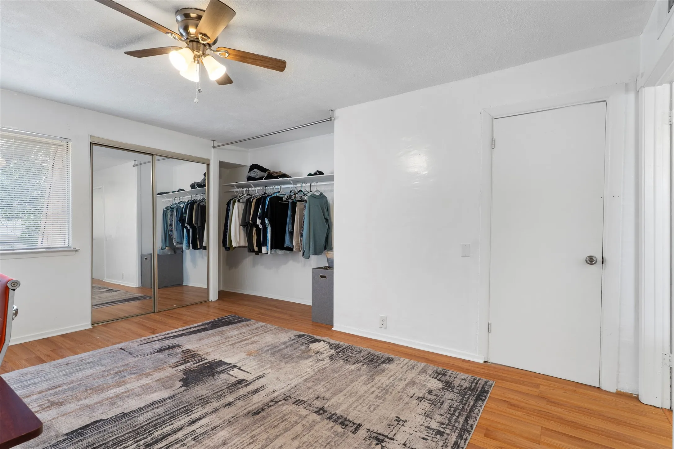 Wood-finish flooring with a ceiling fan light fixture