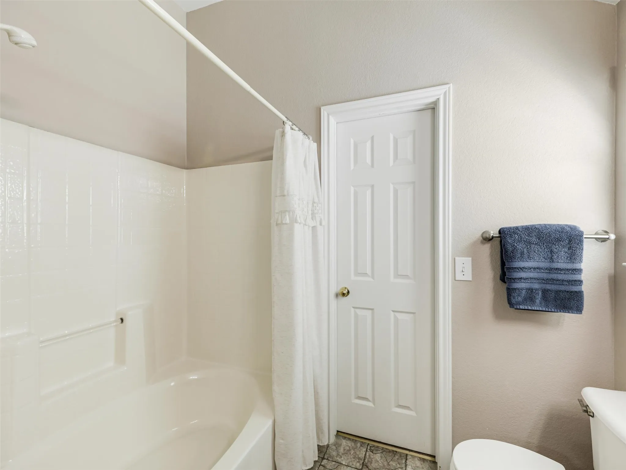Garden tub with shower head and access to large walk in closet