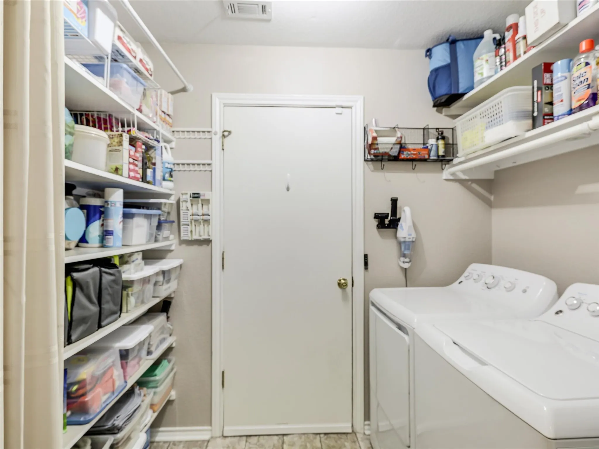 Plenty of shelving in this laundry room