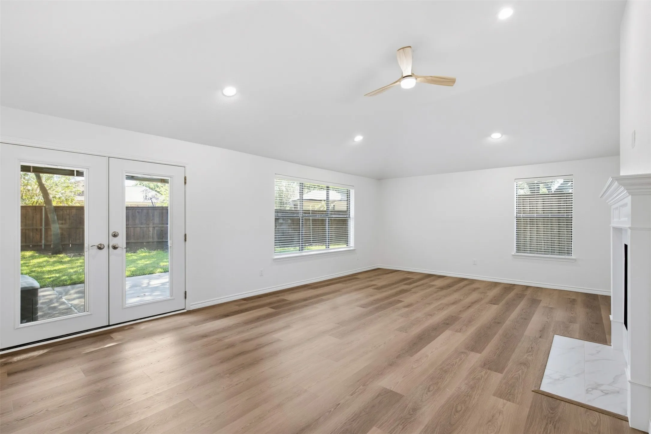 Vaulted ceiling with recessed lighting and a ceiling fan